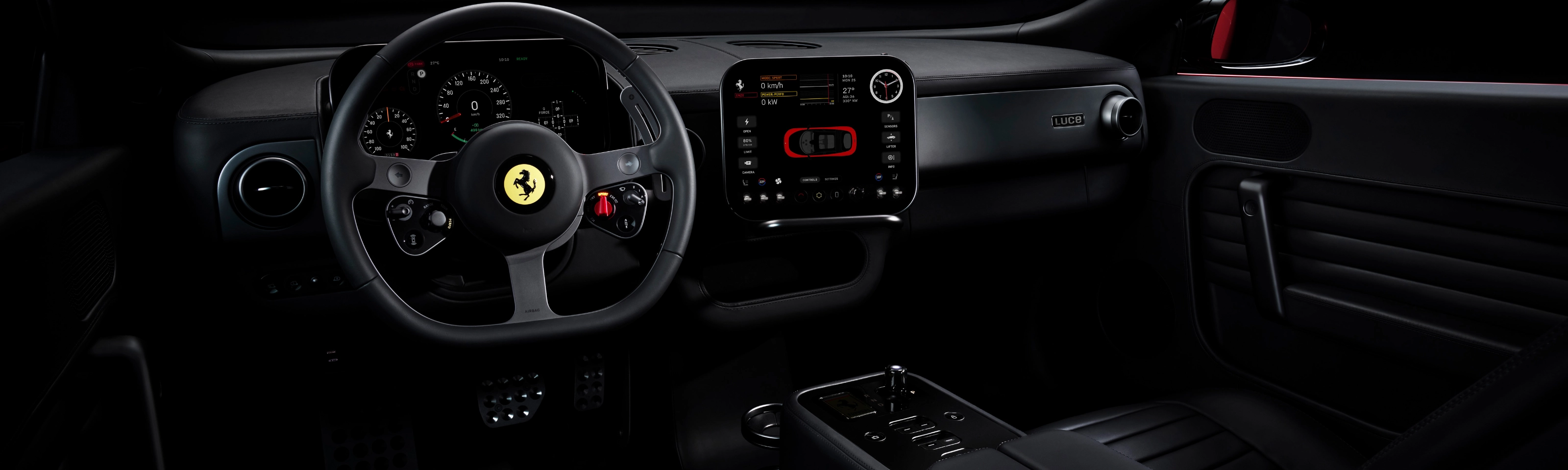 Dark Ferrari interior with illuminated dashboard and steering wheel.