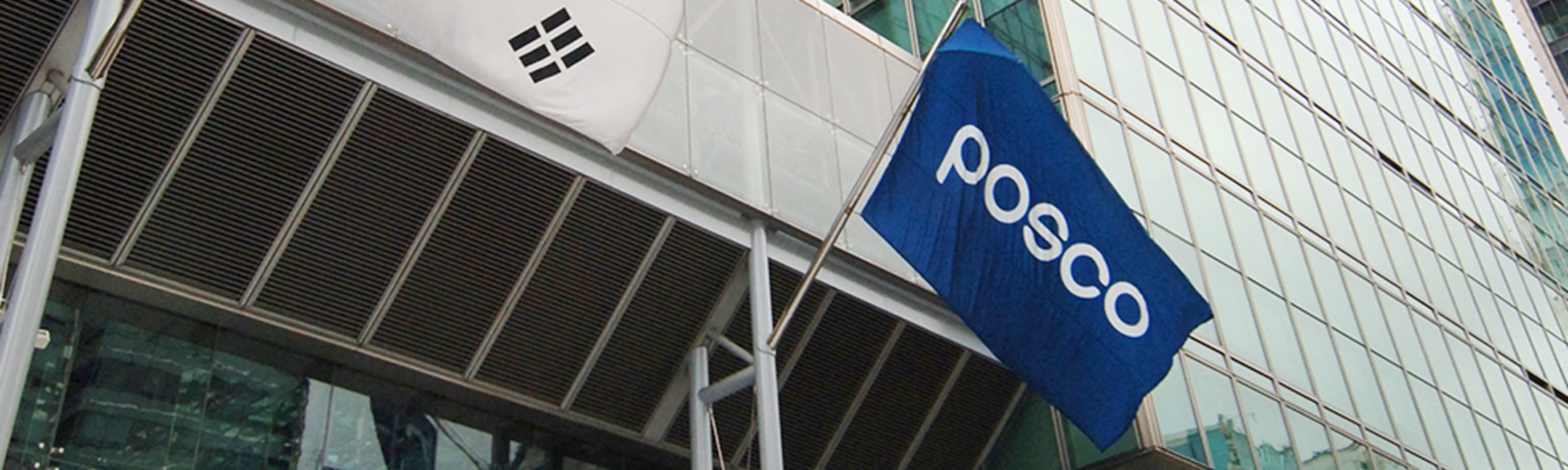 POSCO building entrance with company logo and South Korean flag.