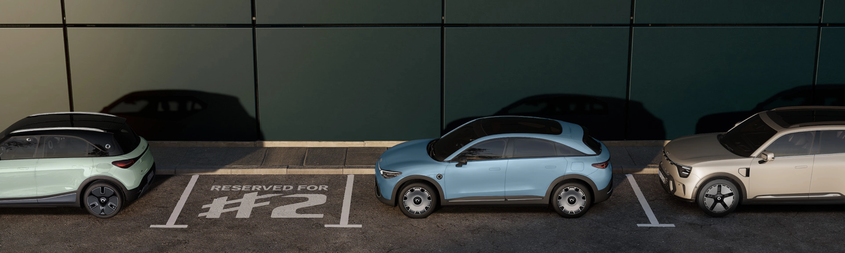 Three parked electric cars in front of a building, with one space marked "Reserved for #2".