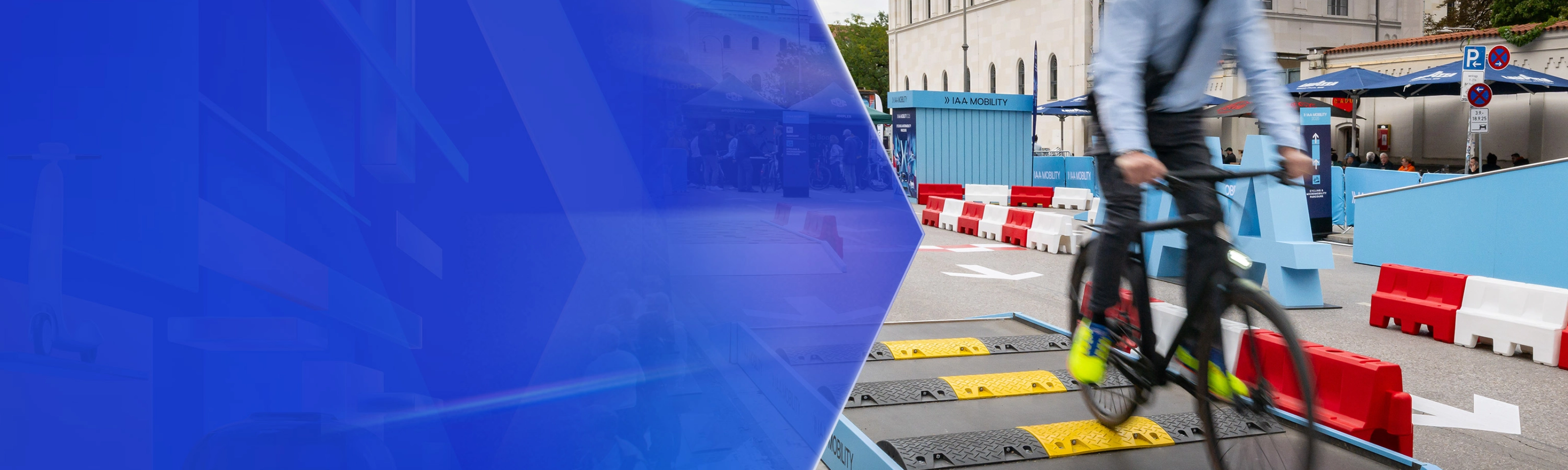 Man riding a bicycle over speed bumps on a test track at IAA Mobility.