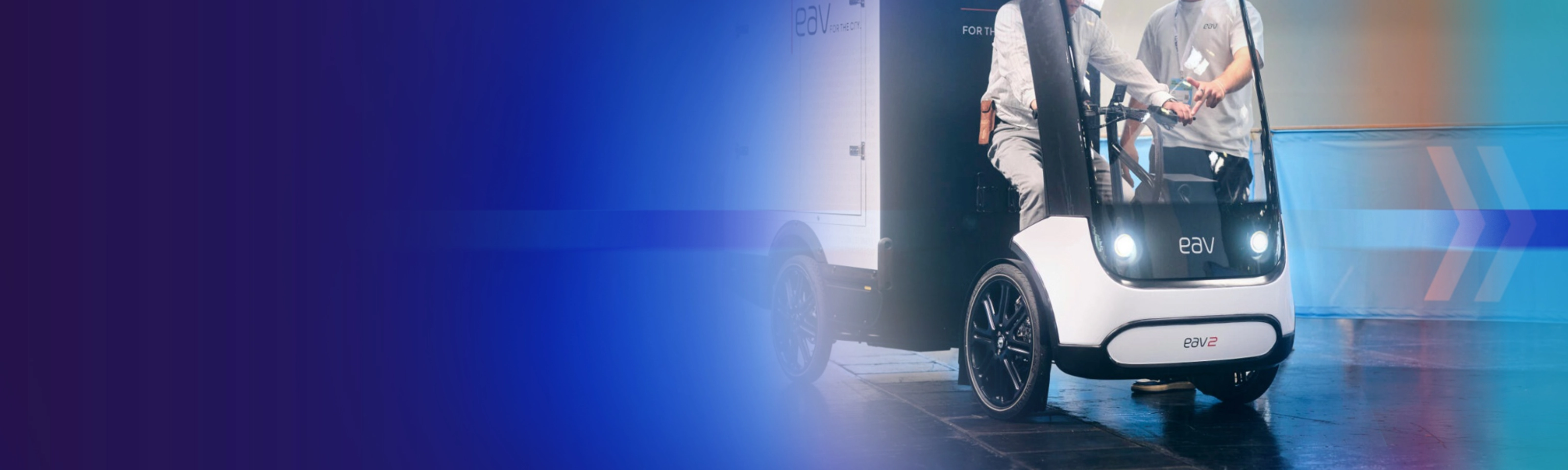 Promotional banner showing an autonomous delivery vehicle on a blue background.