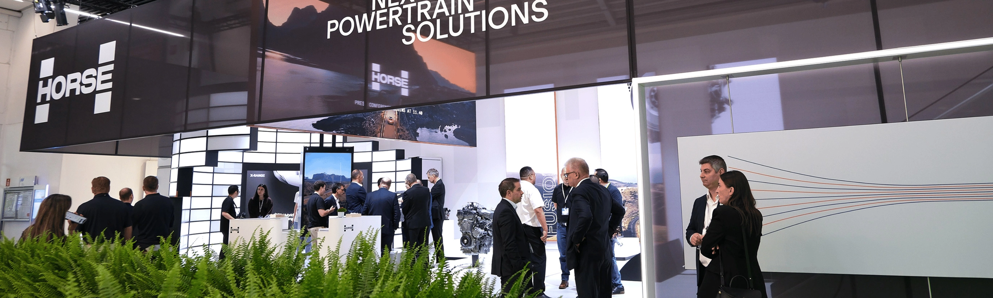 Horse Powertrain exhibition booth with visitors at an automotive trade show.