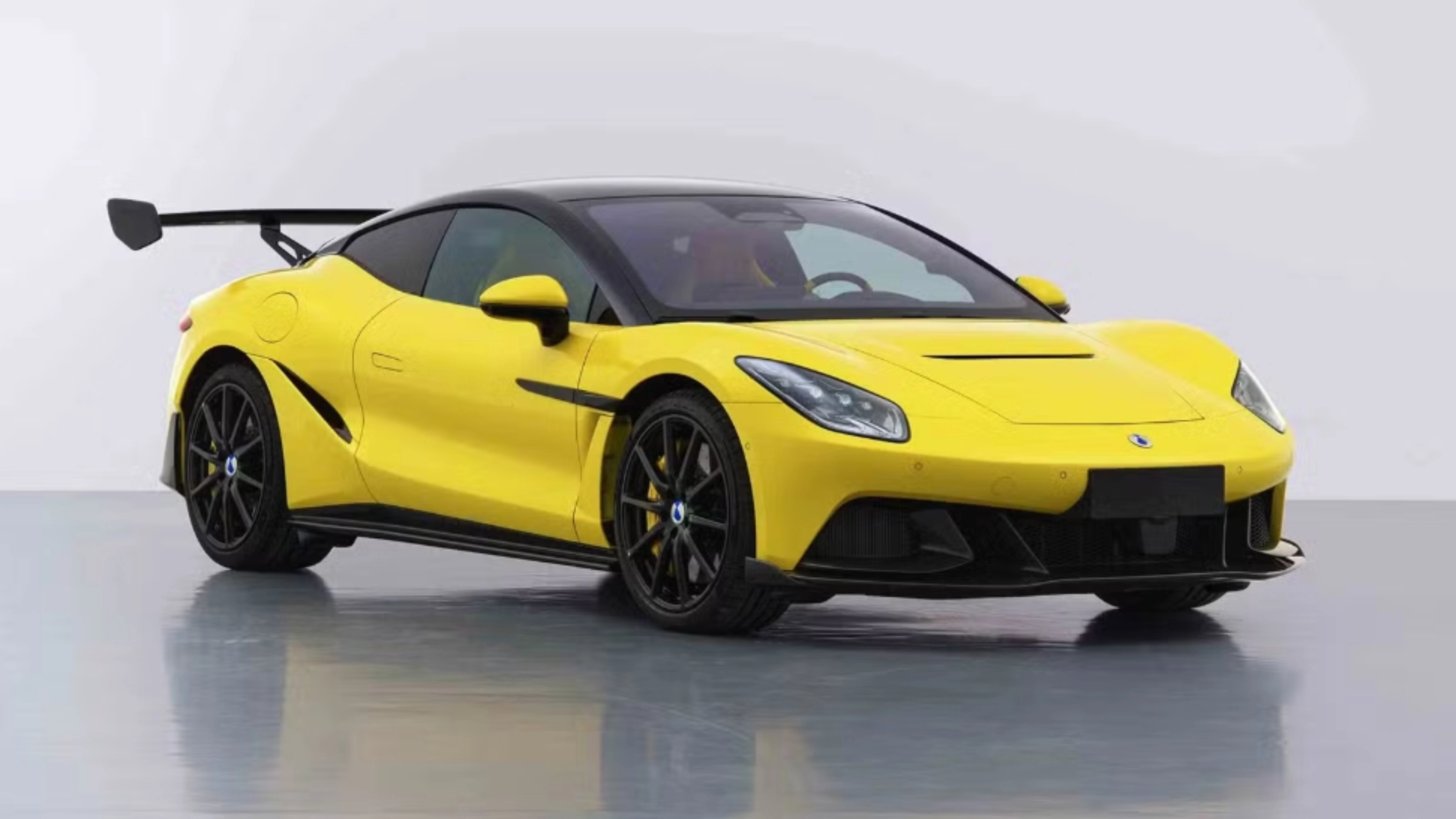 Yellow Denza Z sports car by BYD with rear wing on white studio background.
