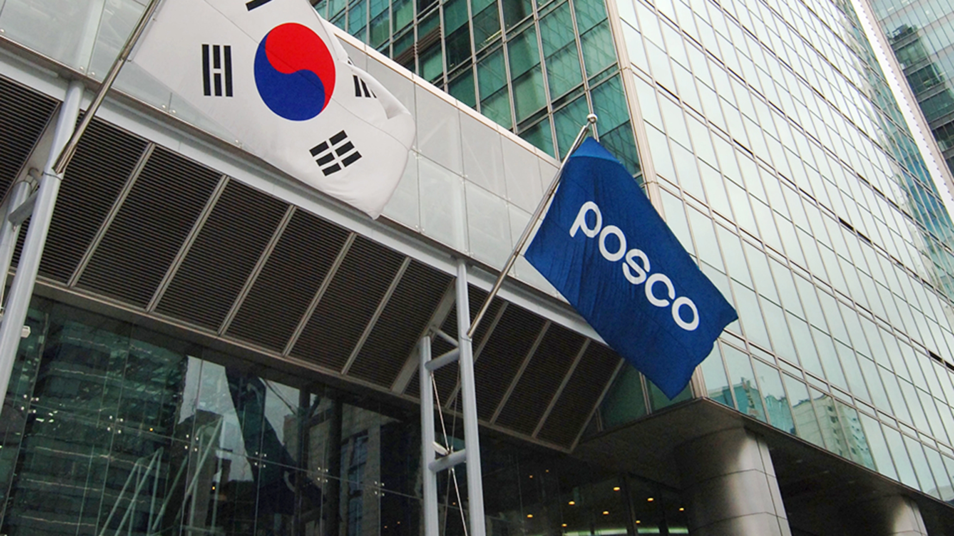POSCO building entrance with company logo and South Korean flag.