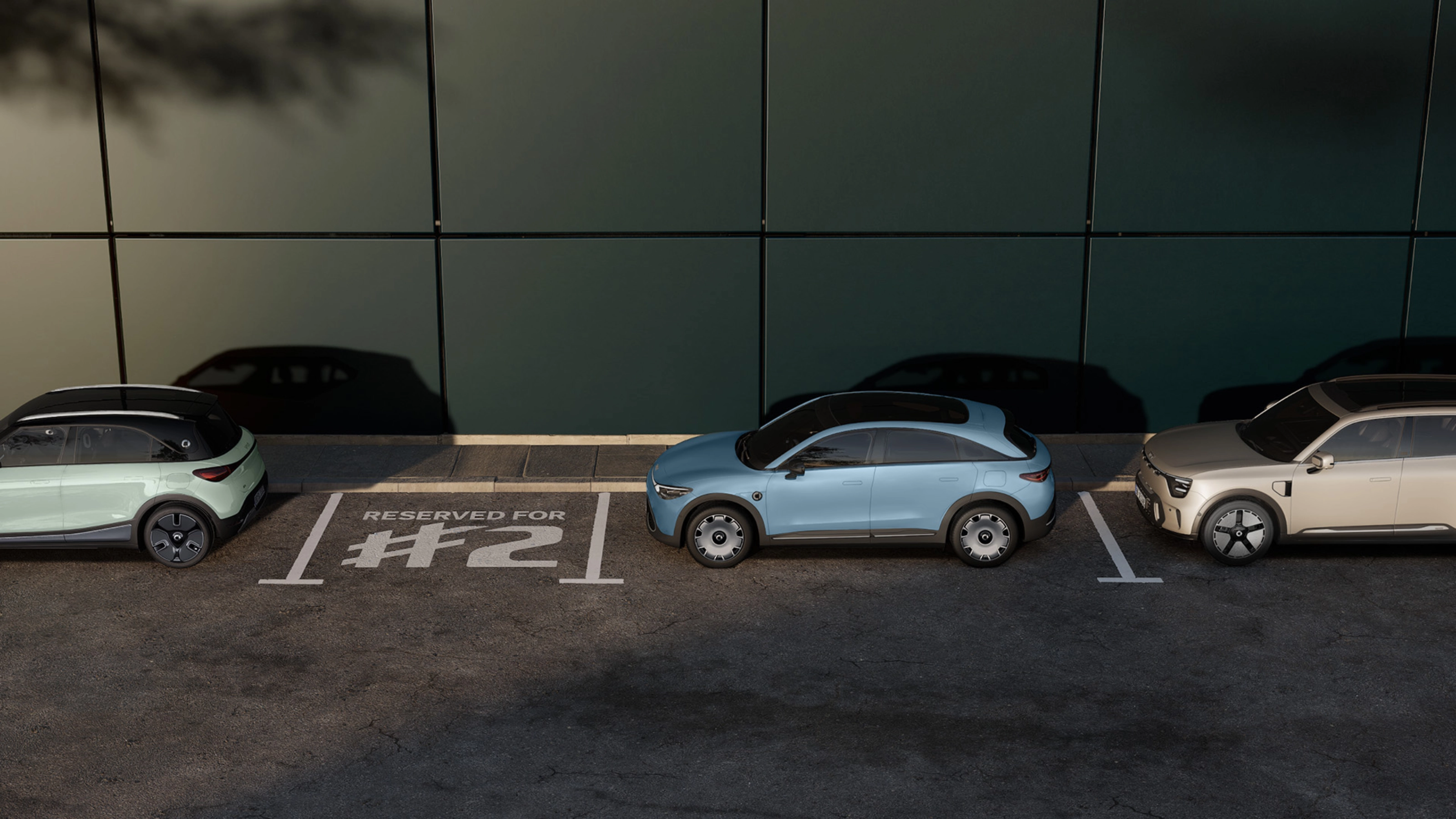 Three parked electric cars in front of a building, with one space marked "Reserved for #2".