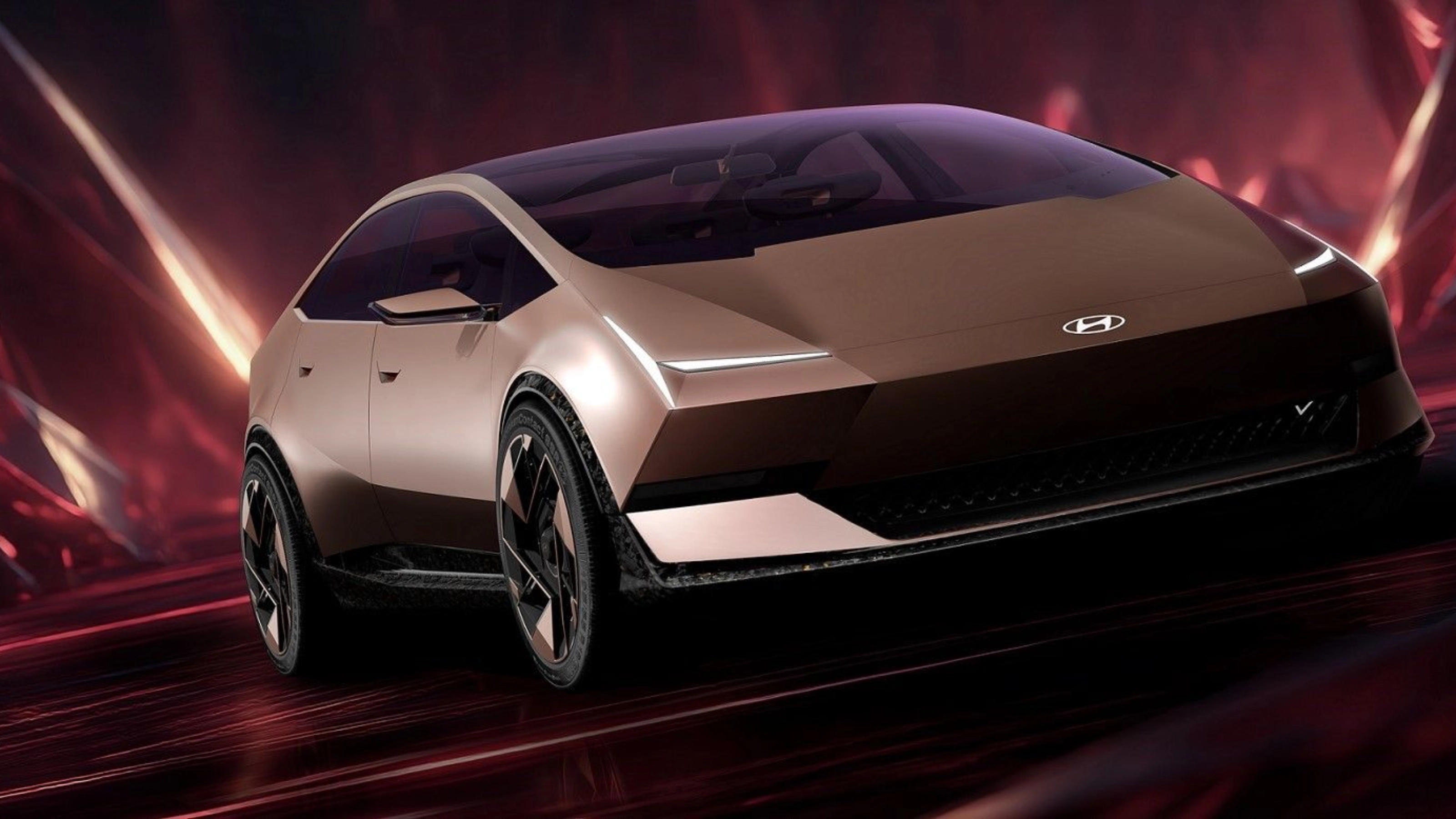 Futuristic Hyundai electric car driving in a red illuminated studio setting.
