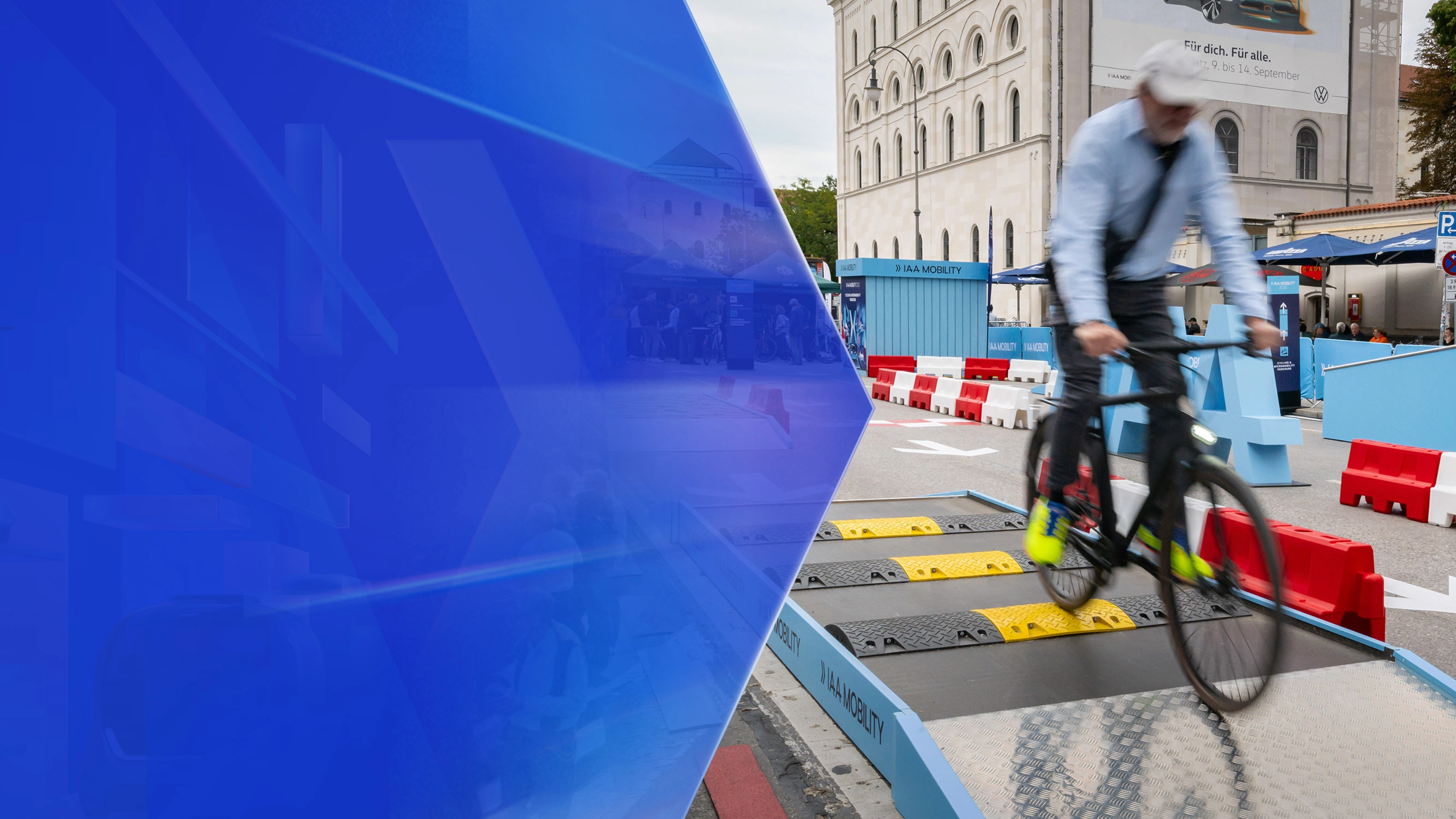 Man riding a bicycle over speed bumps on a test track at IAA Mobility.