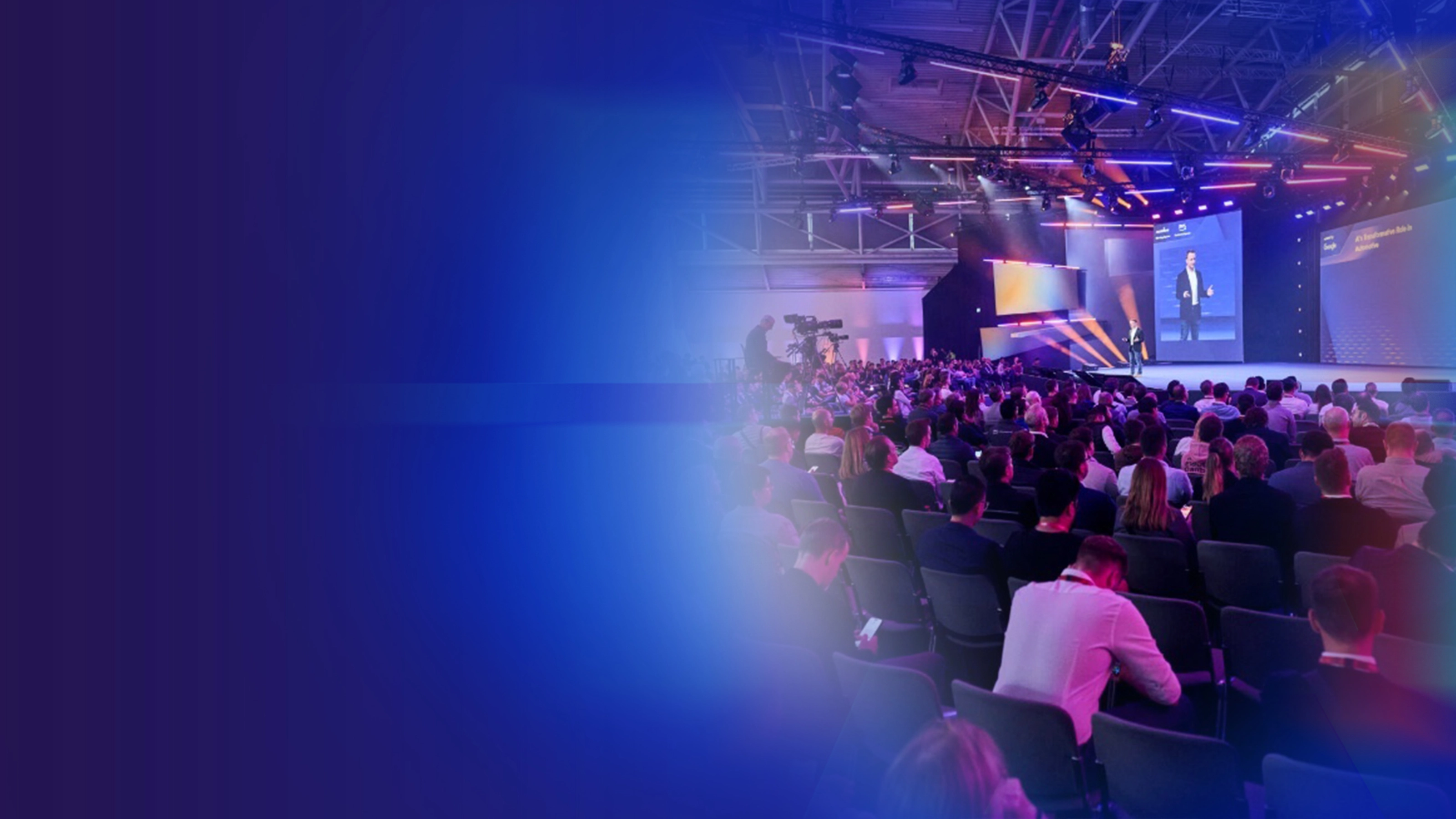 Promotional banner showing a conference audience and stage presentation.