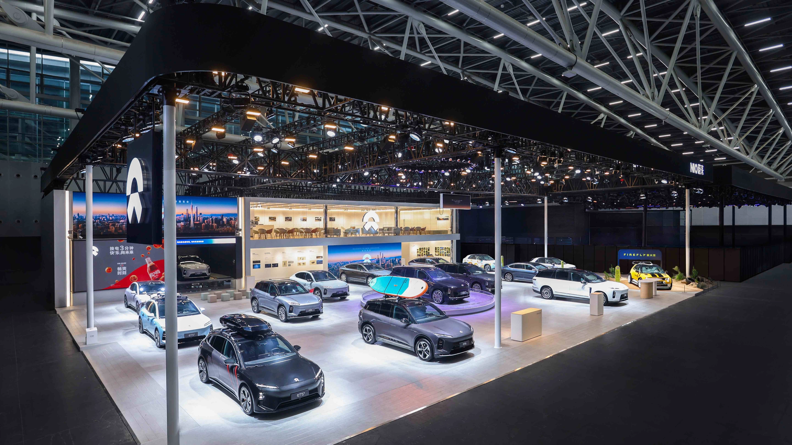 NIO exhibition booth displaying multiple electric cars at an auto show.