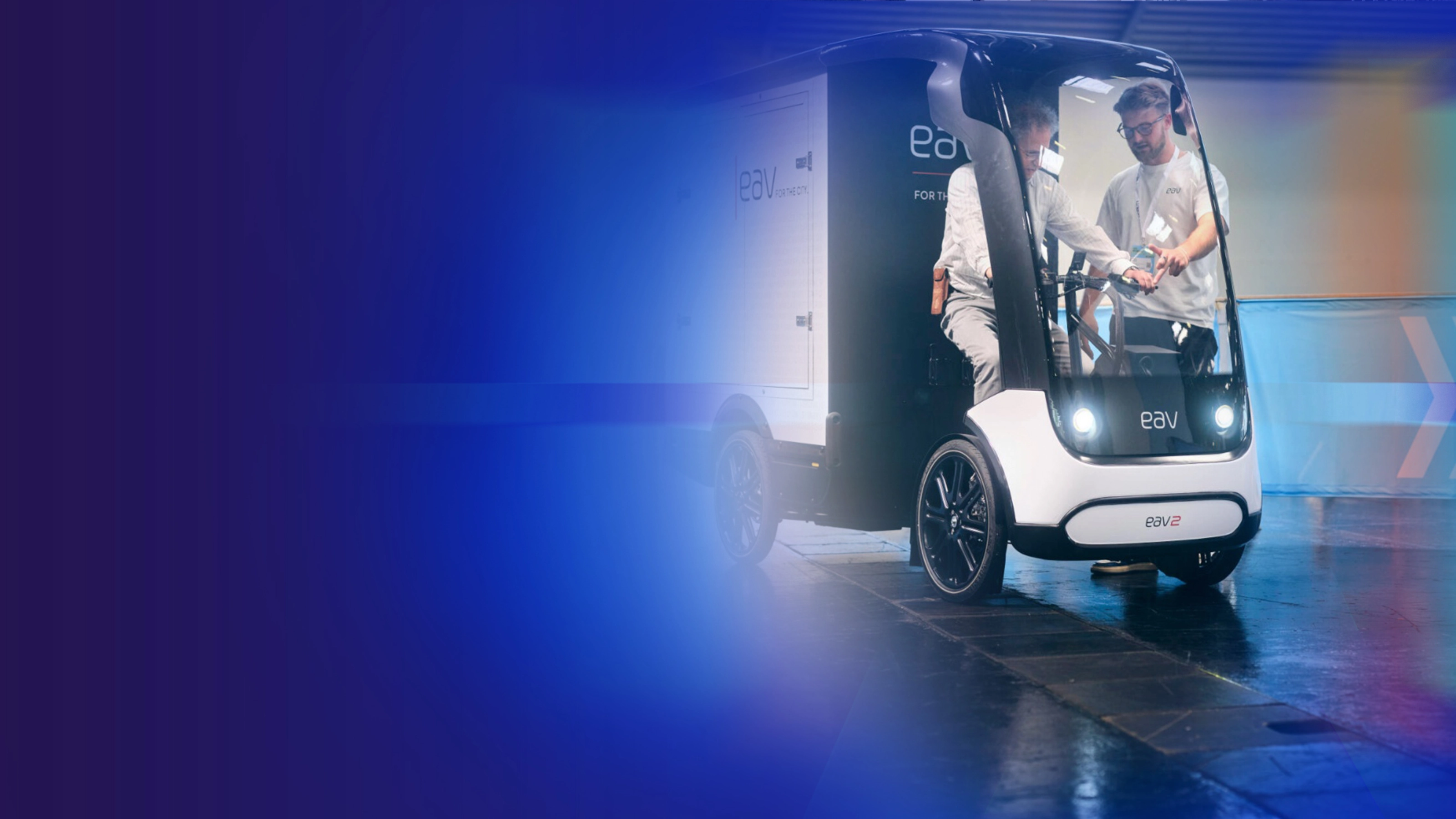 Promotional banner showing an autonomous delivery vehicle on a blue background.
