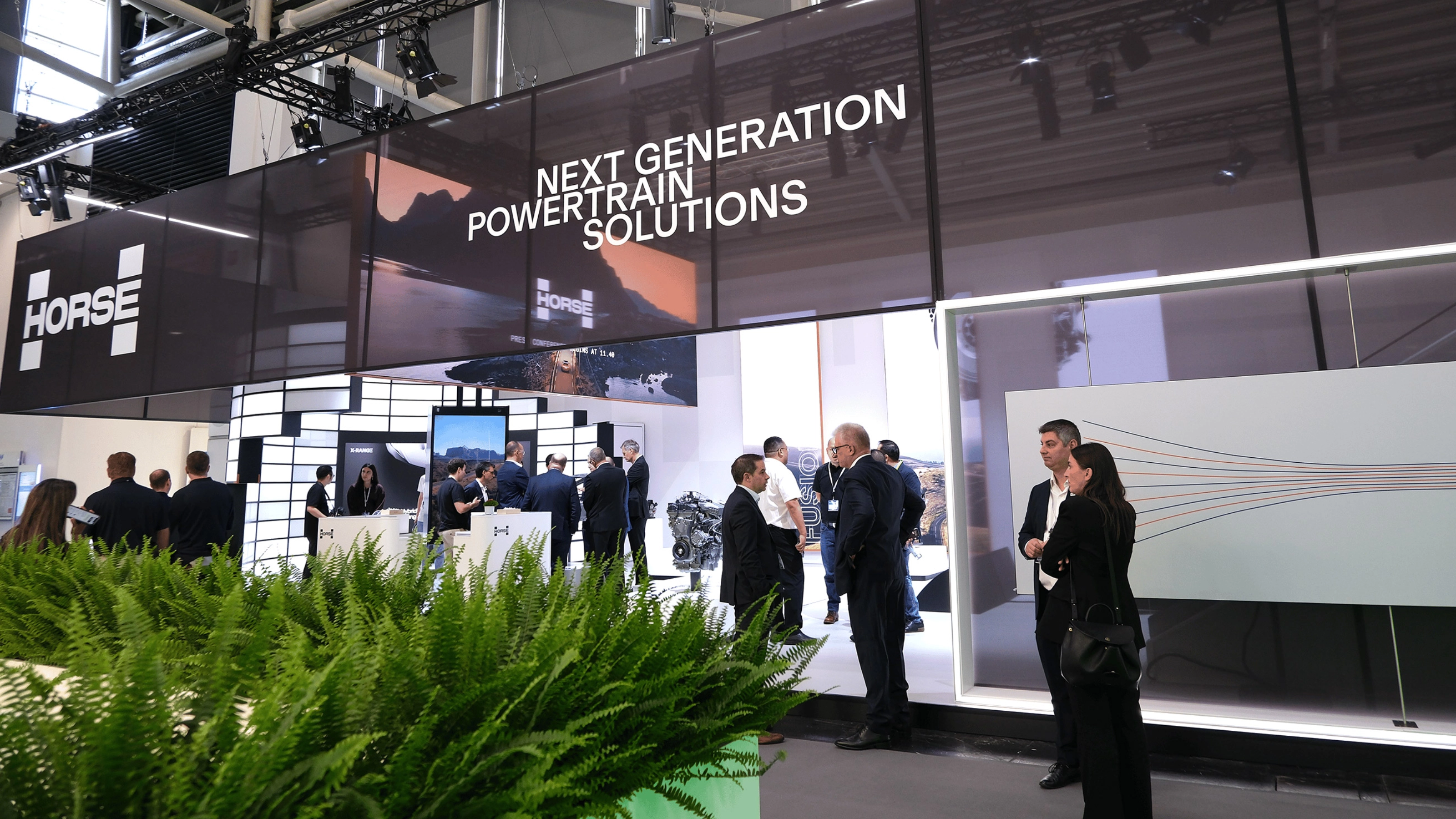 Horse Powertrain exhibition booth with visitors at an automotive trade show.