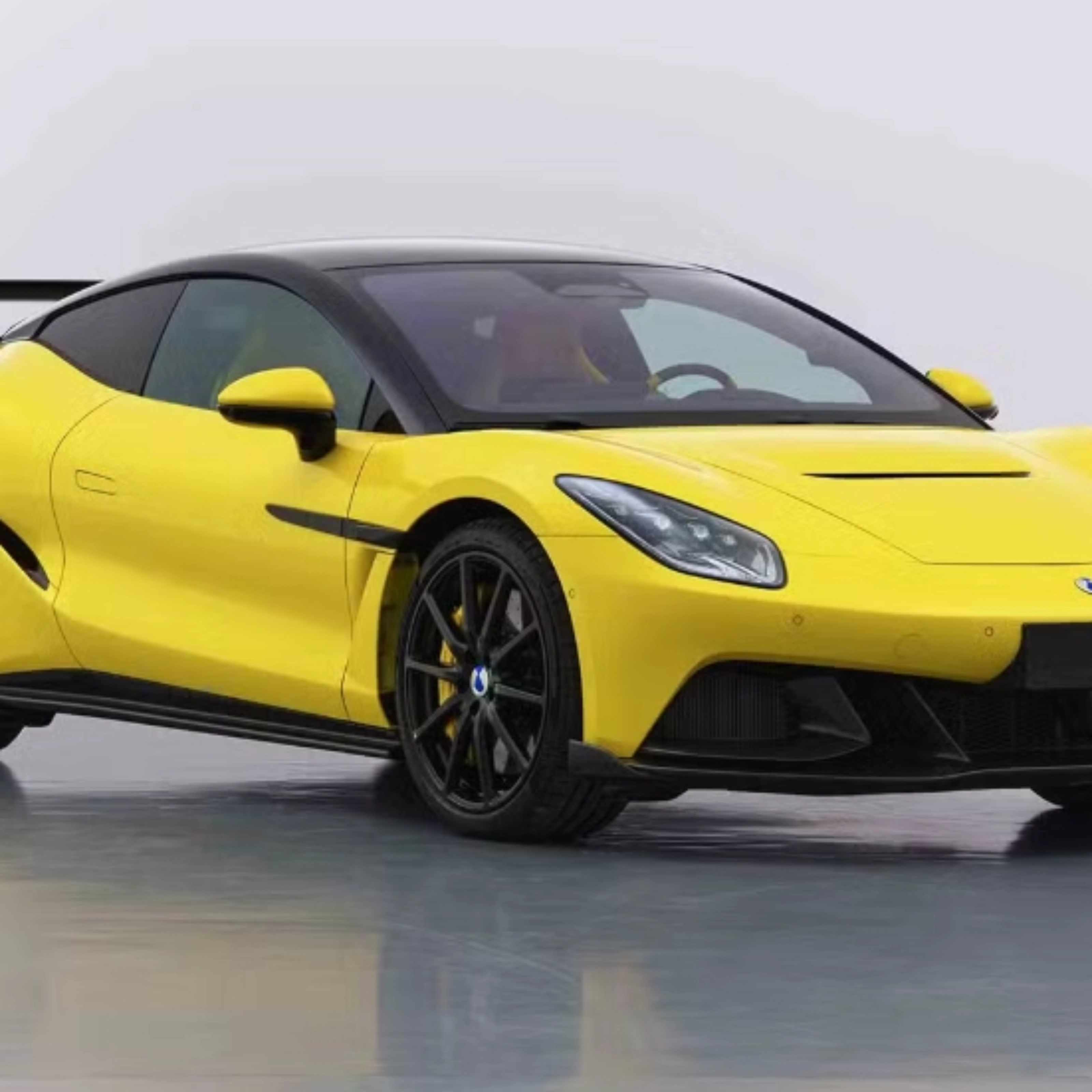 Yellow Denza Z sports car by BYD with rear wing on white studio background.