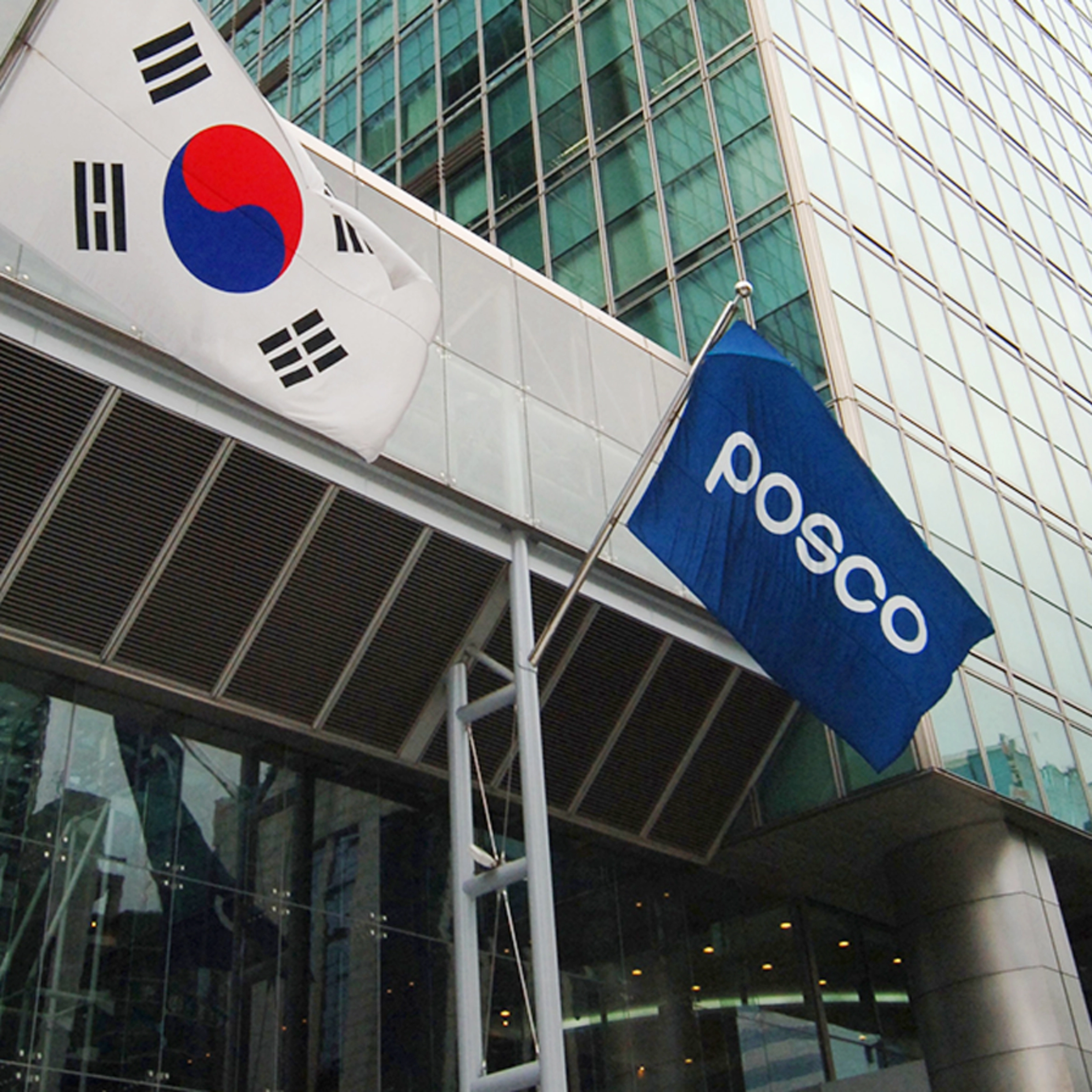 POSCO building entrance with company logo and South Korean flag.