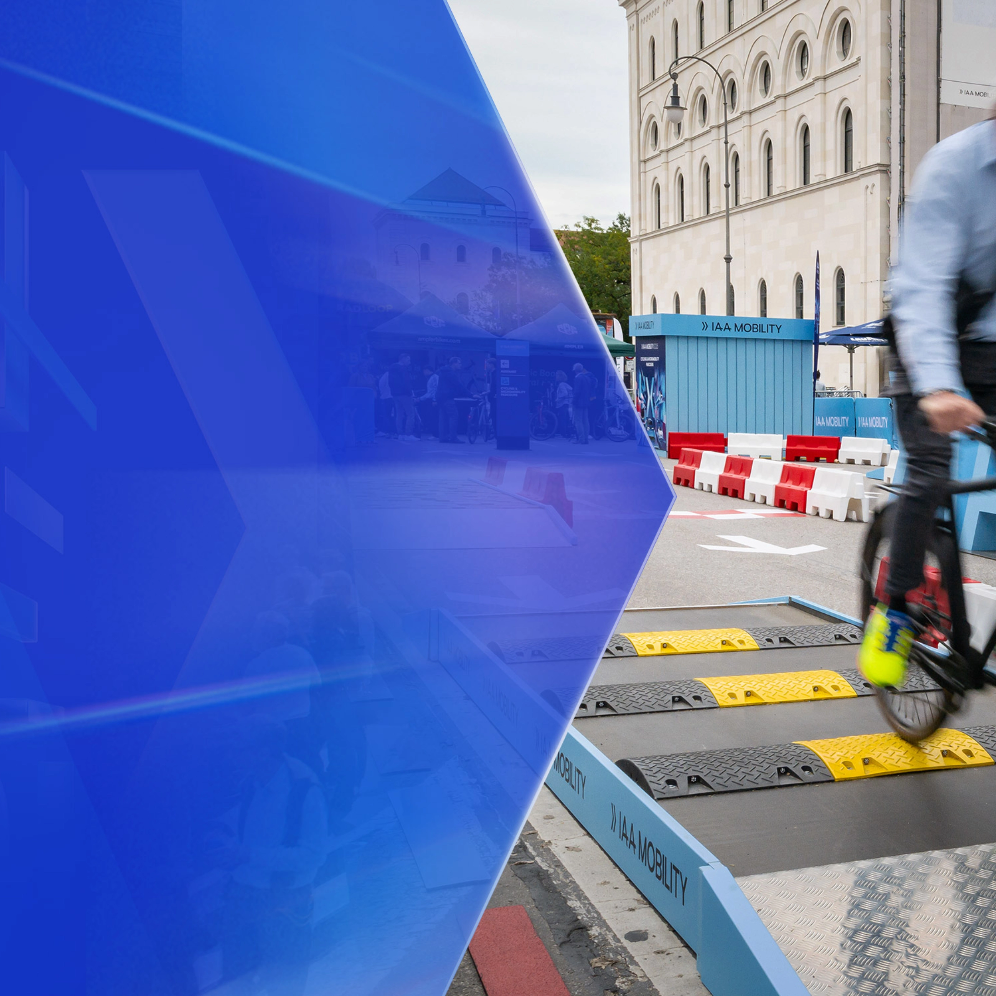 Man riding a bicycle over speed bumps on a test track at IAA Mobility.