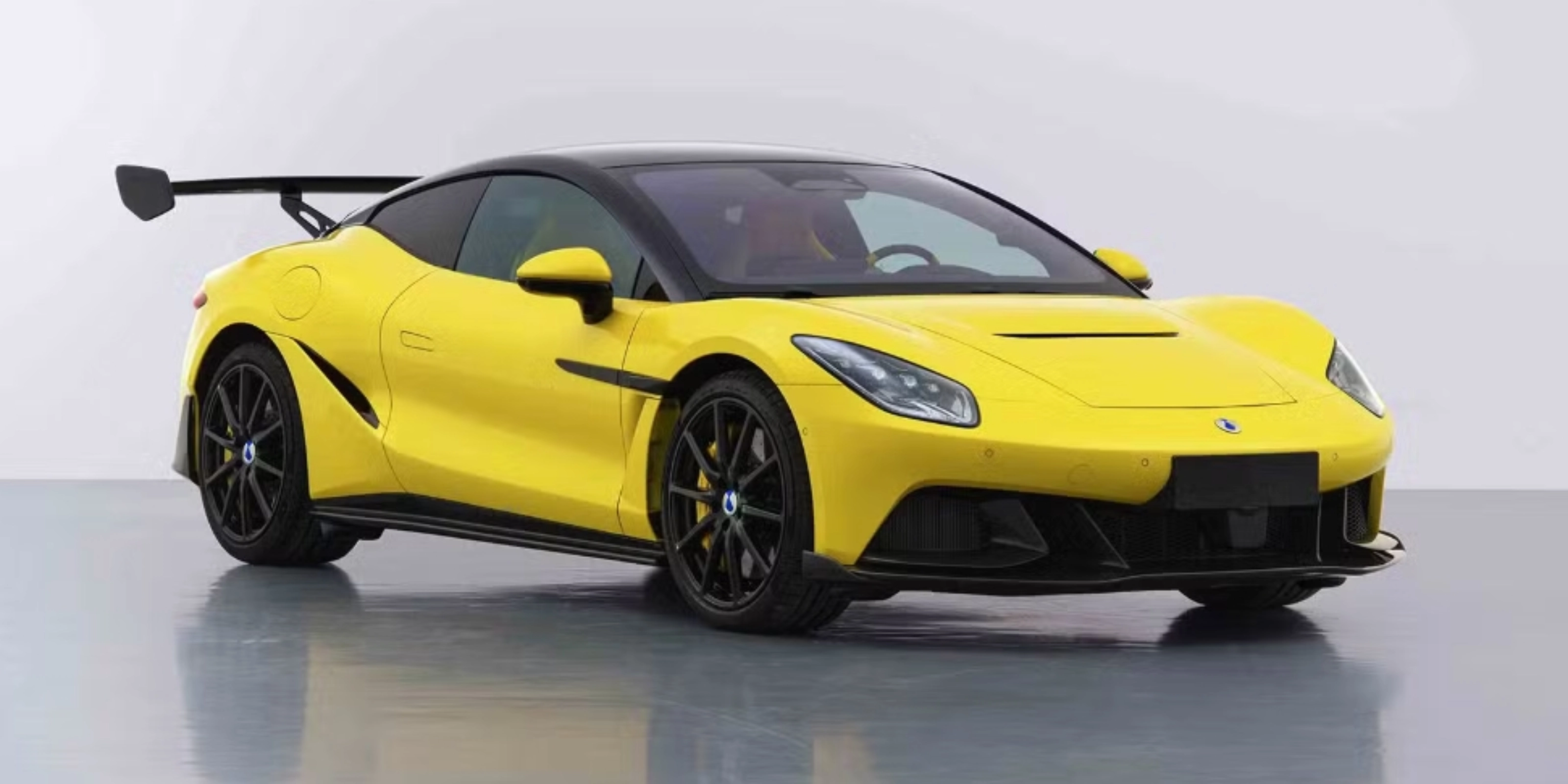 Yellow Denza Z sports car by BYD with rear wing on white studio background.