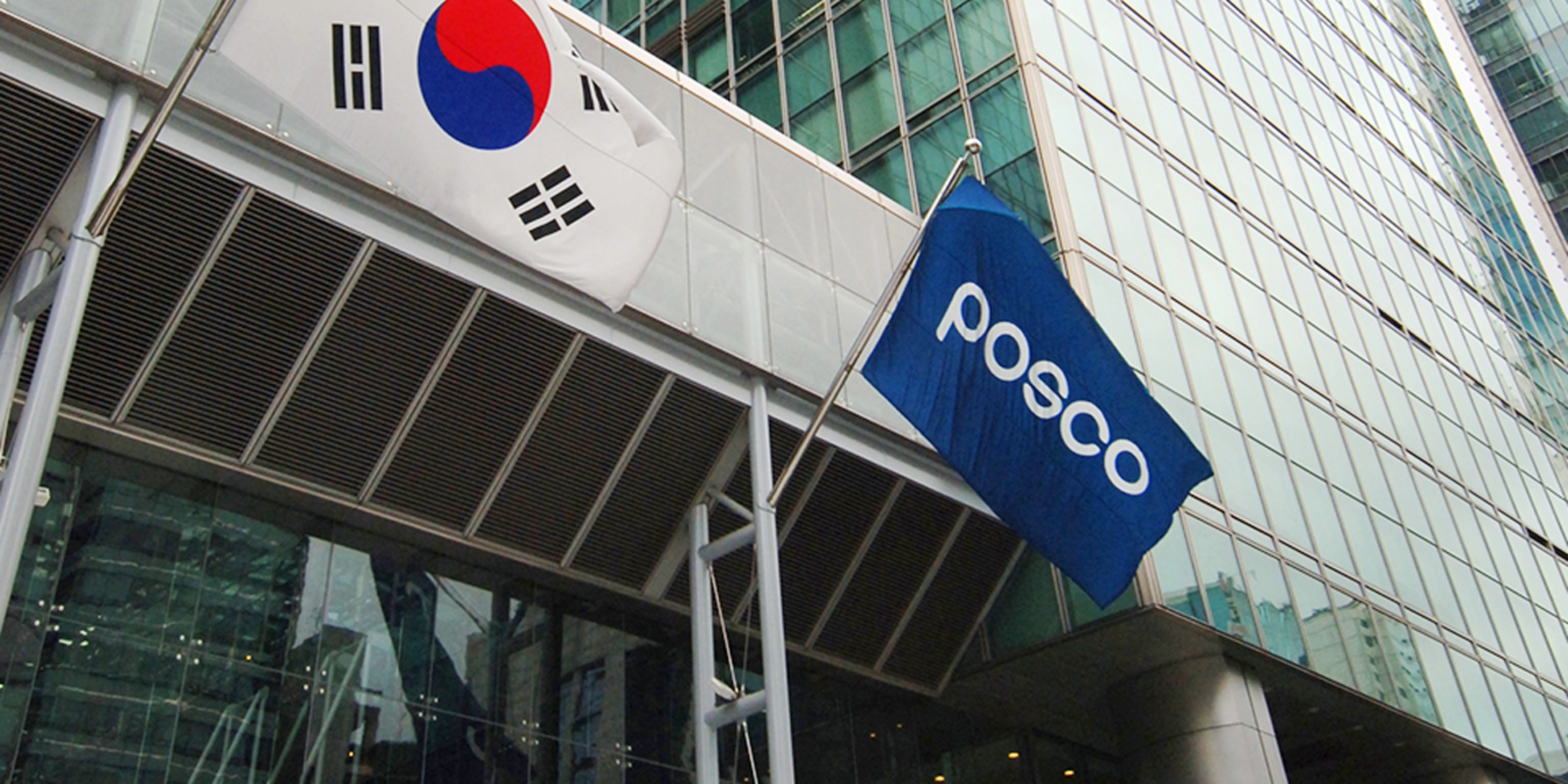 POSCO building entrance with company logo and South Korean flag.