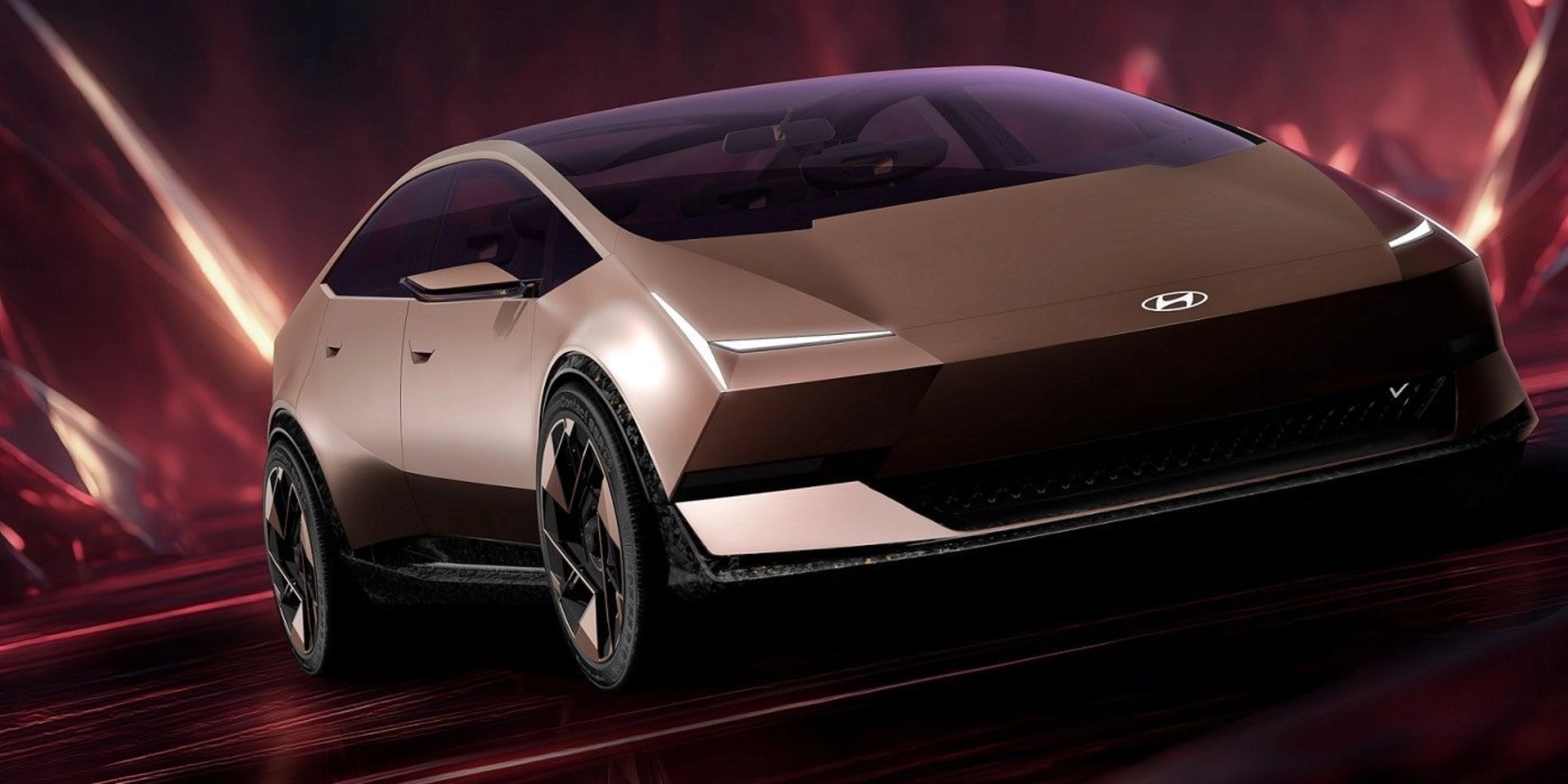 Futuristic Hyundai electric car driving in a red illuminated studio setting.