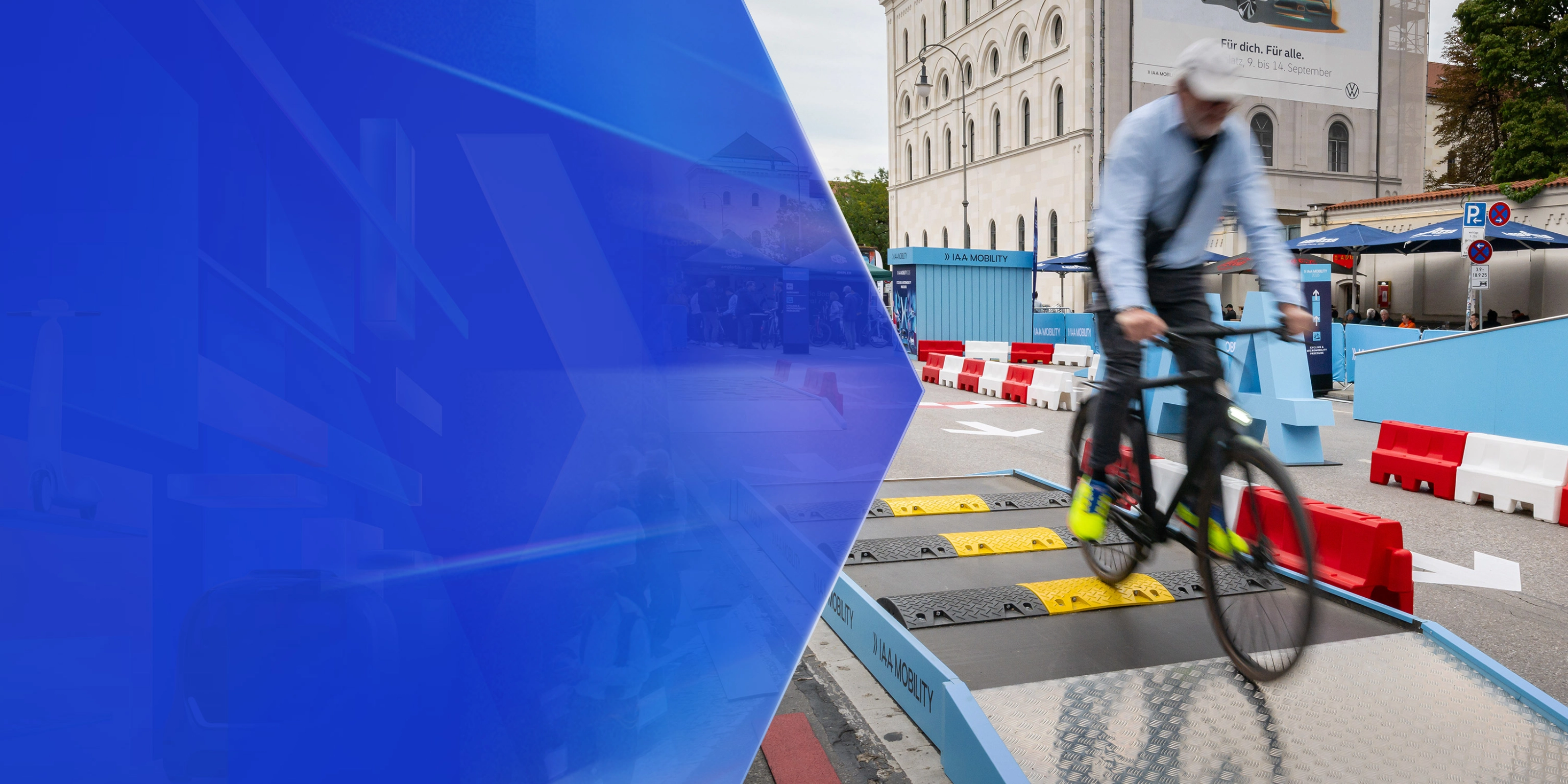 Man riding a bicycle over speed bumps on a test track at IAA Mobility.