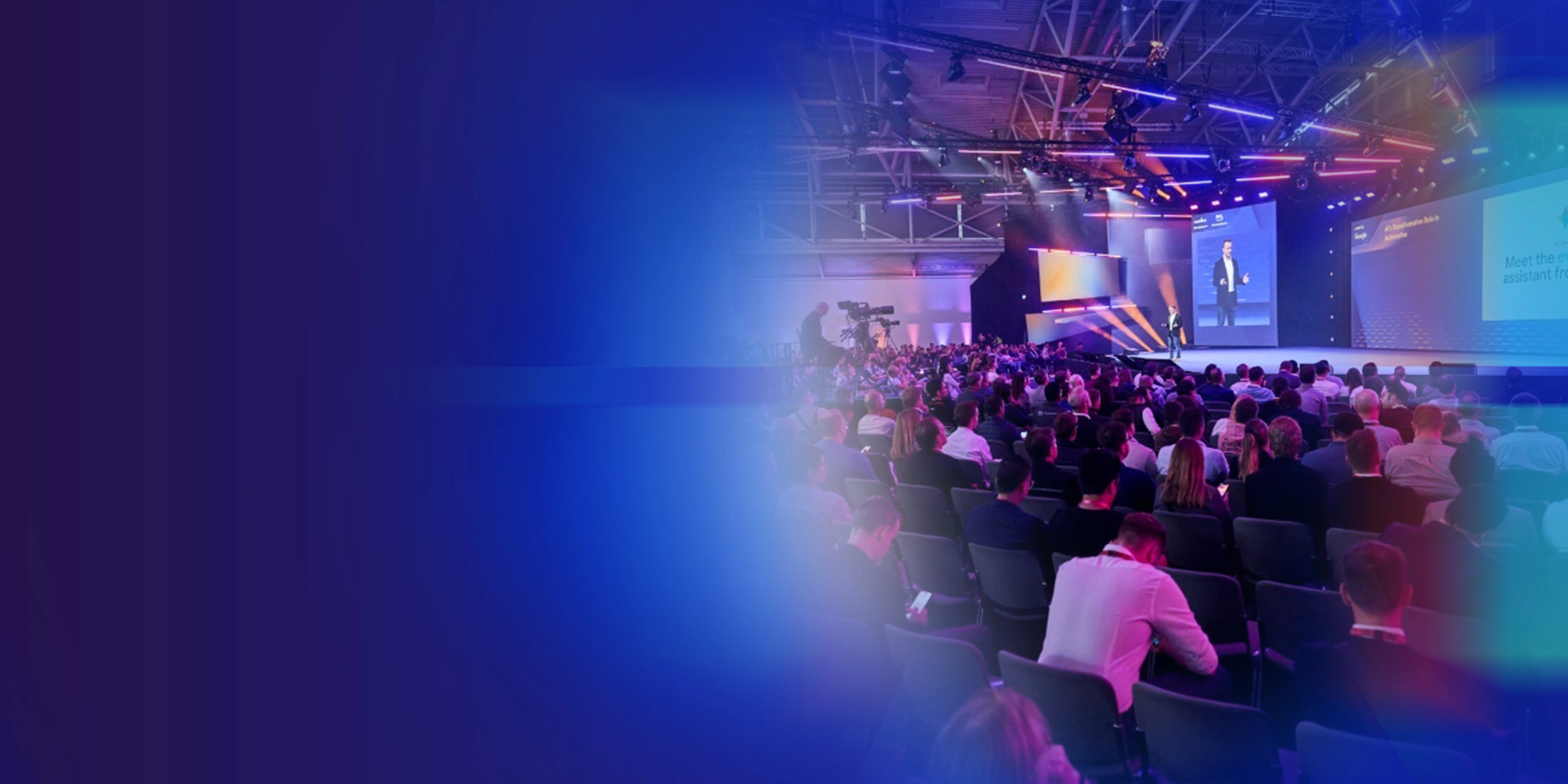 Promotional banner showing a conference audience and stage presentation.