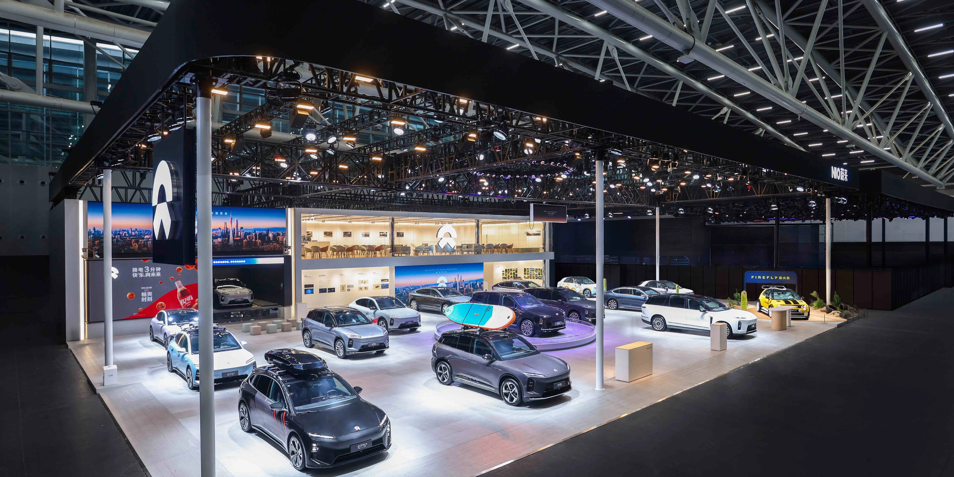 NIO exhibition booth displaying multiple electric cars at an auto show.
