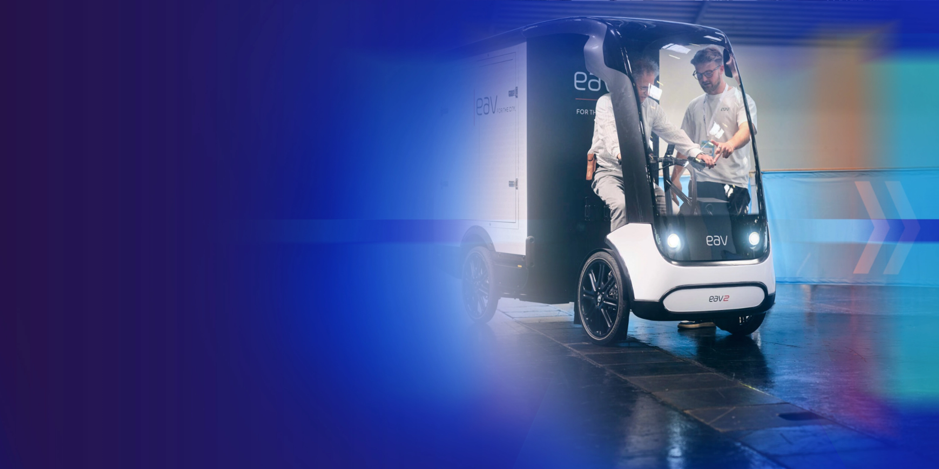 Promotional banner showing an autonomous delivery vehicle on a blue background.