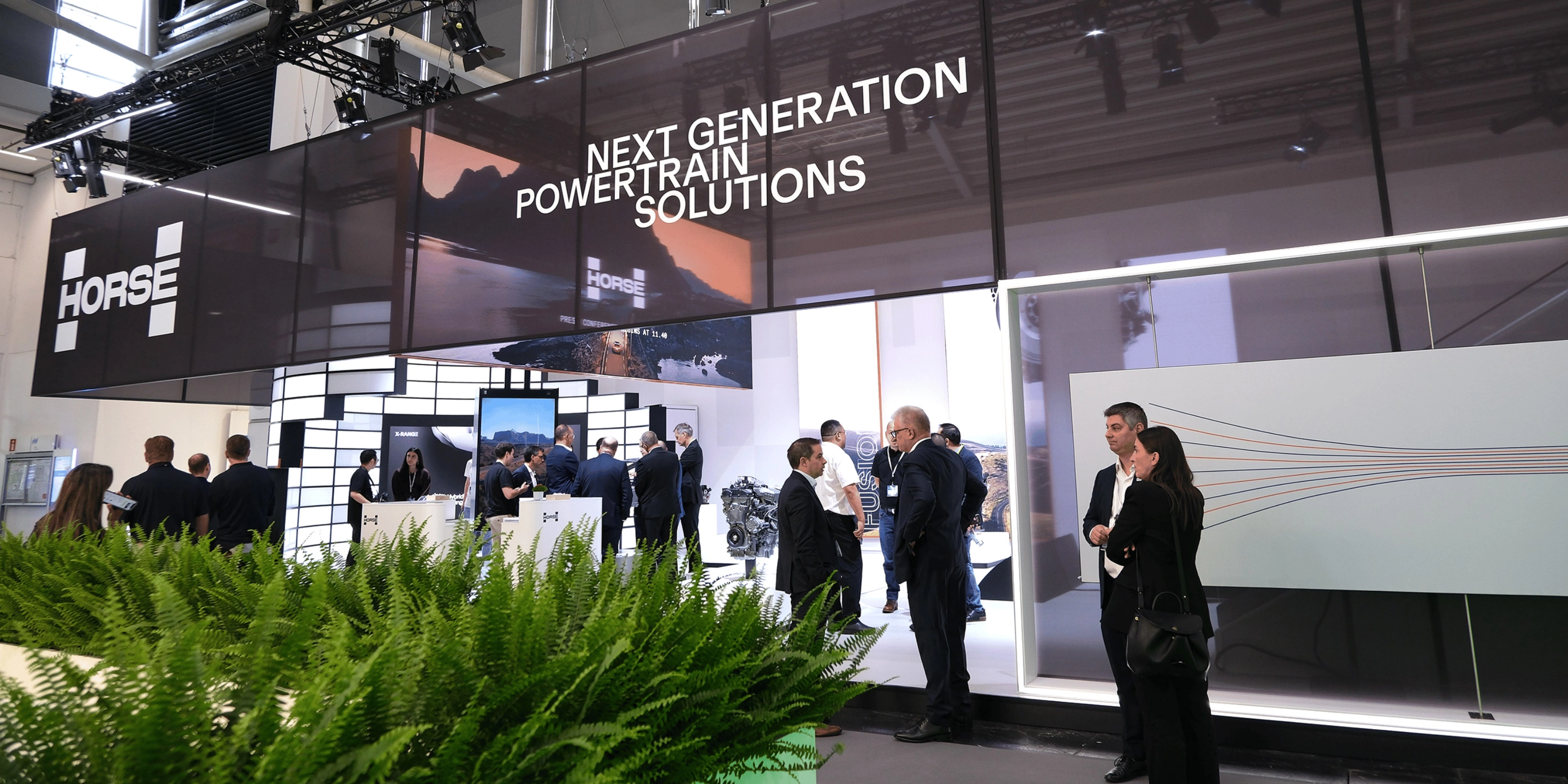 Horse Powertrain exhibition booth with visitors at an automotive trade show.