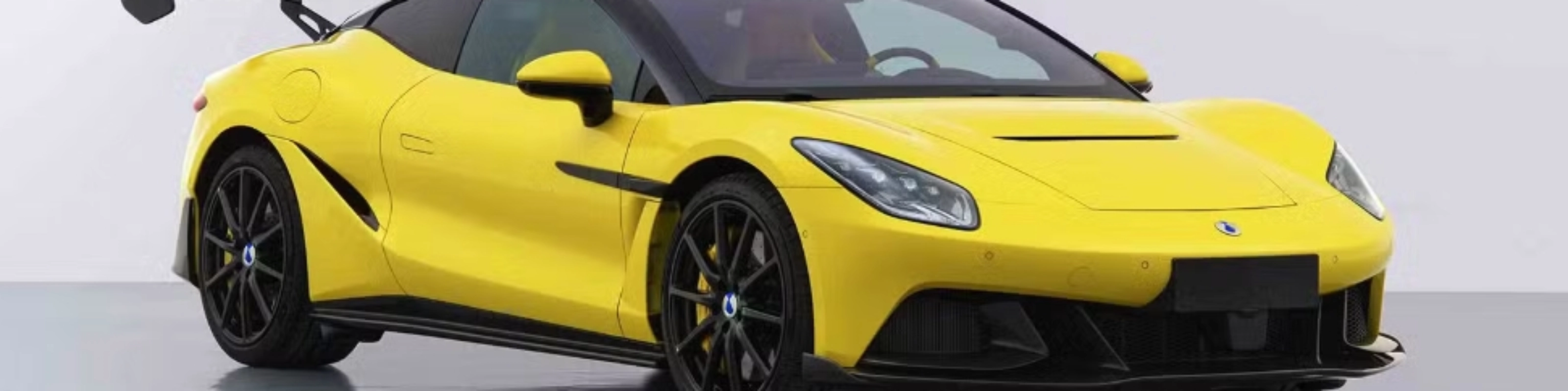 Yellow Denza Z sports car by BYD with rear wing on white studio background.