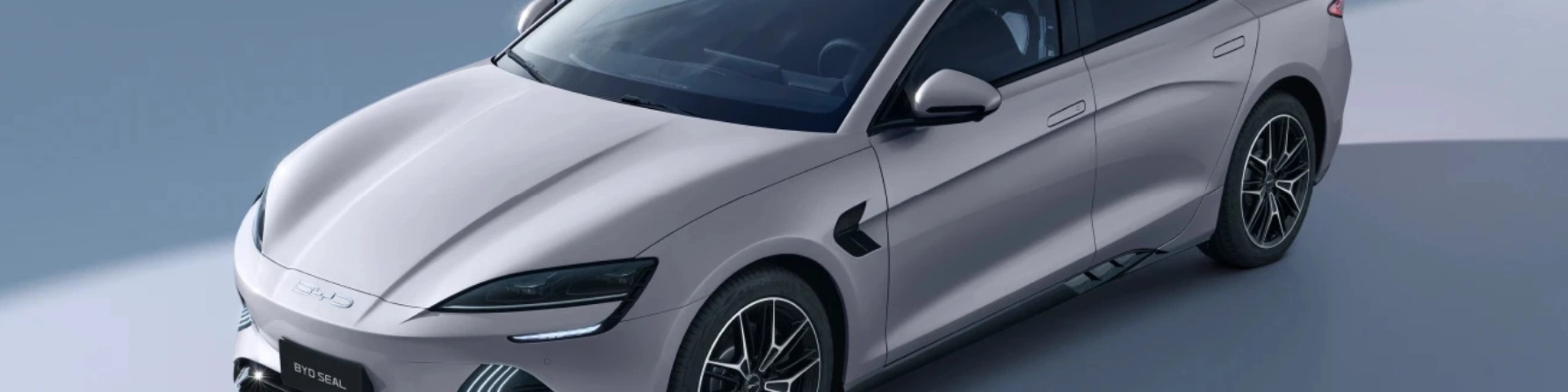 BYD Seal electric sedan in light gray, shown from a front-side angle.