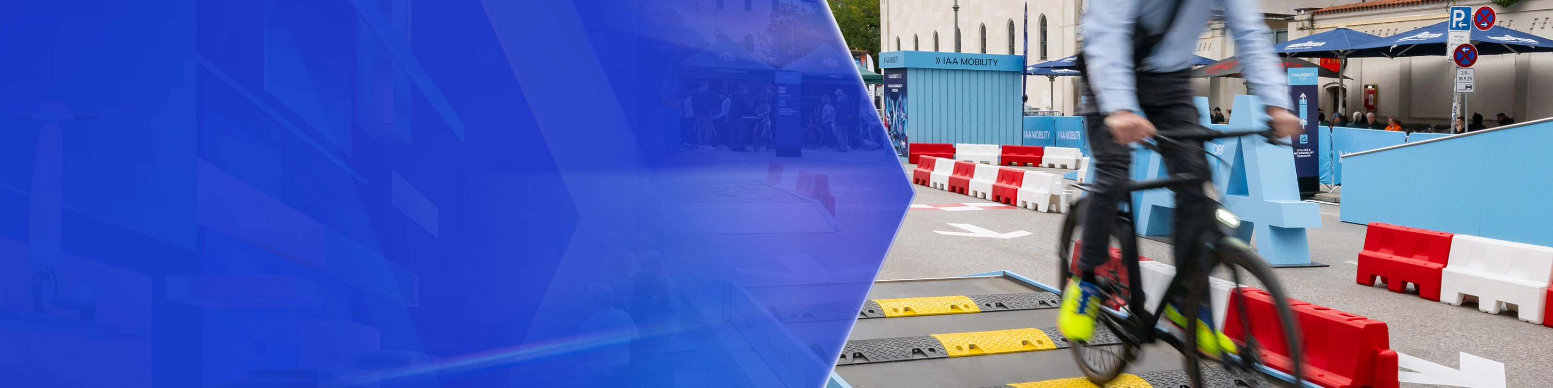Man riding a bicycle over speed bumps on a test track at IAA Mobility.