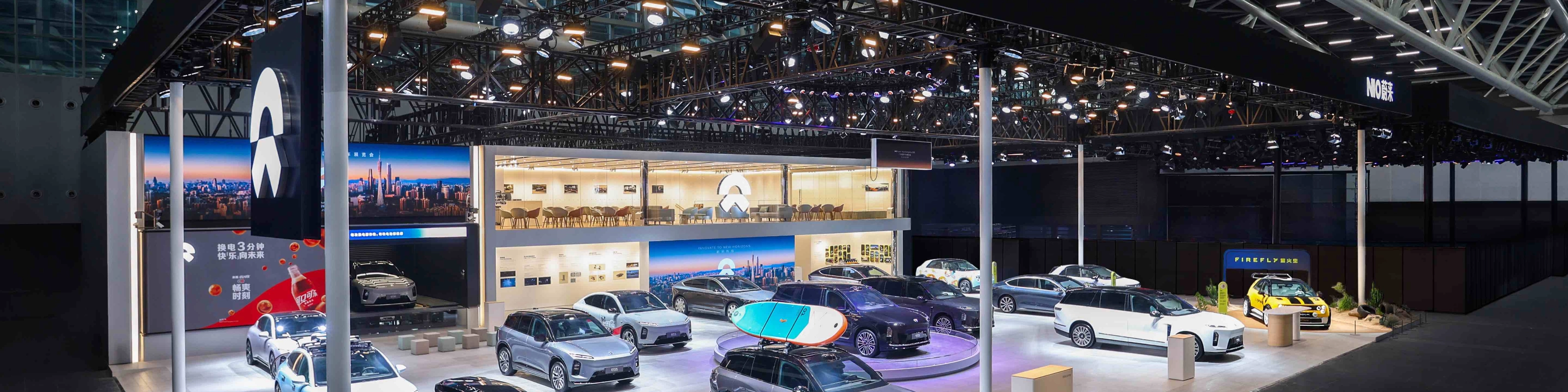 NIO exhibition booth displaying multiple electric cars at an auto show.