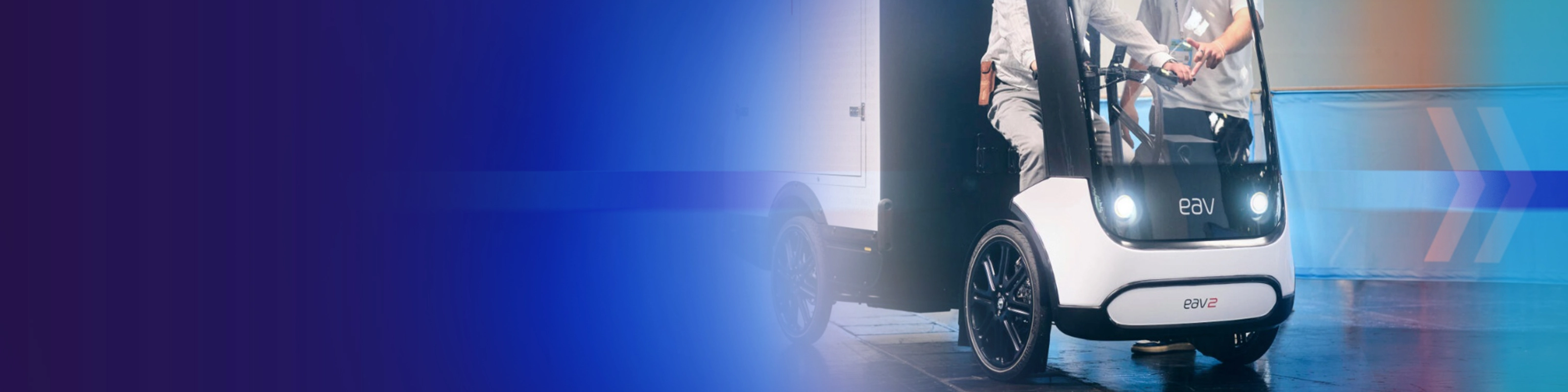 Promotional banner showing an autonomous delivery vehicle on a blue background.