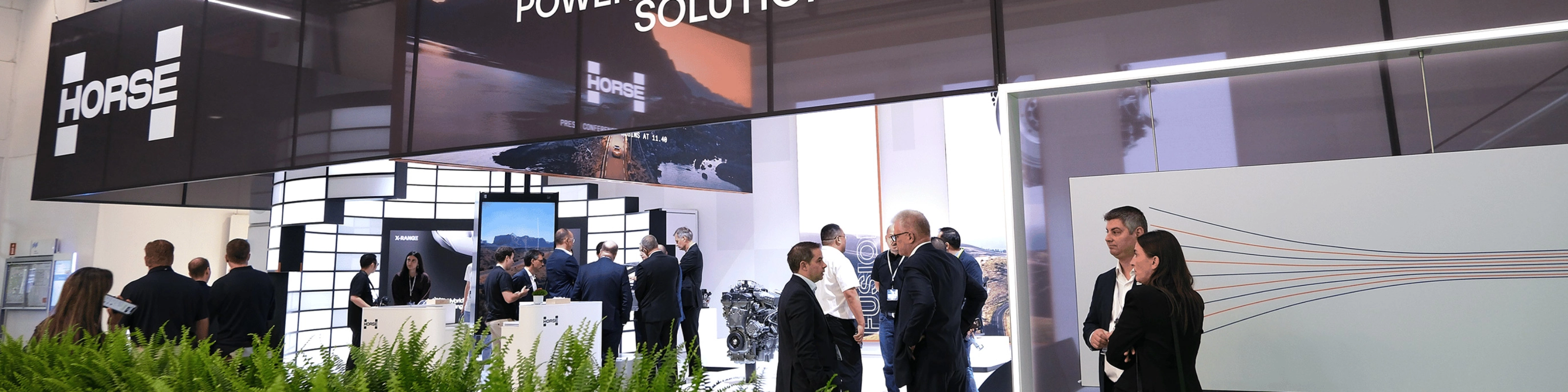 Horse Powertrain exhibition booth with visitors at an automotive trade show.