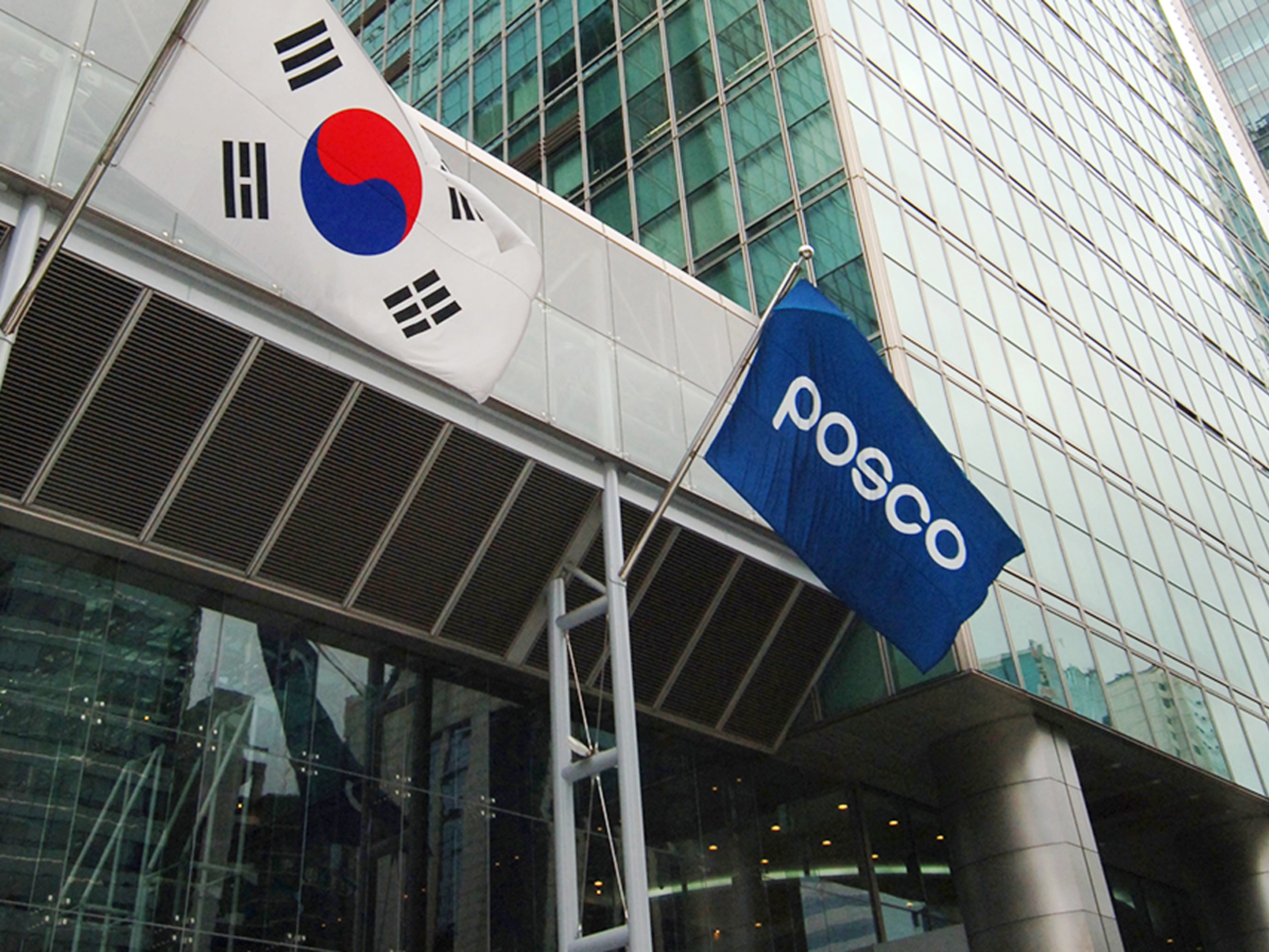 POSCO building entrance with company logo and South Korean flag.