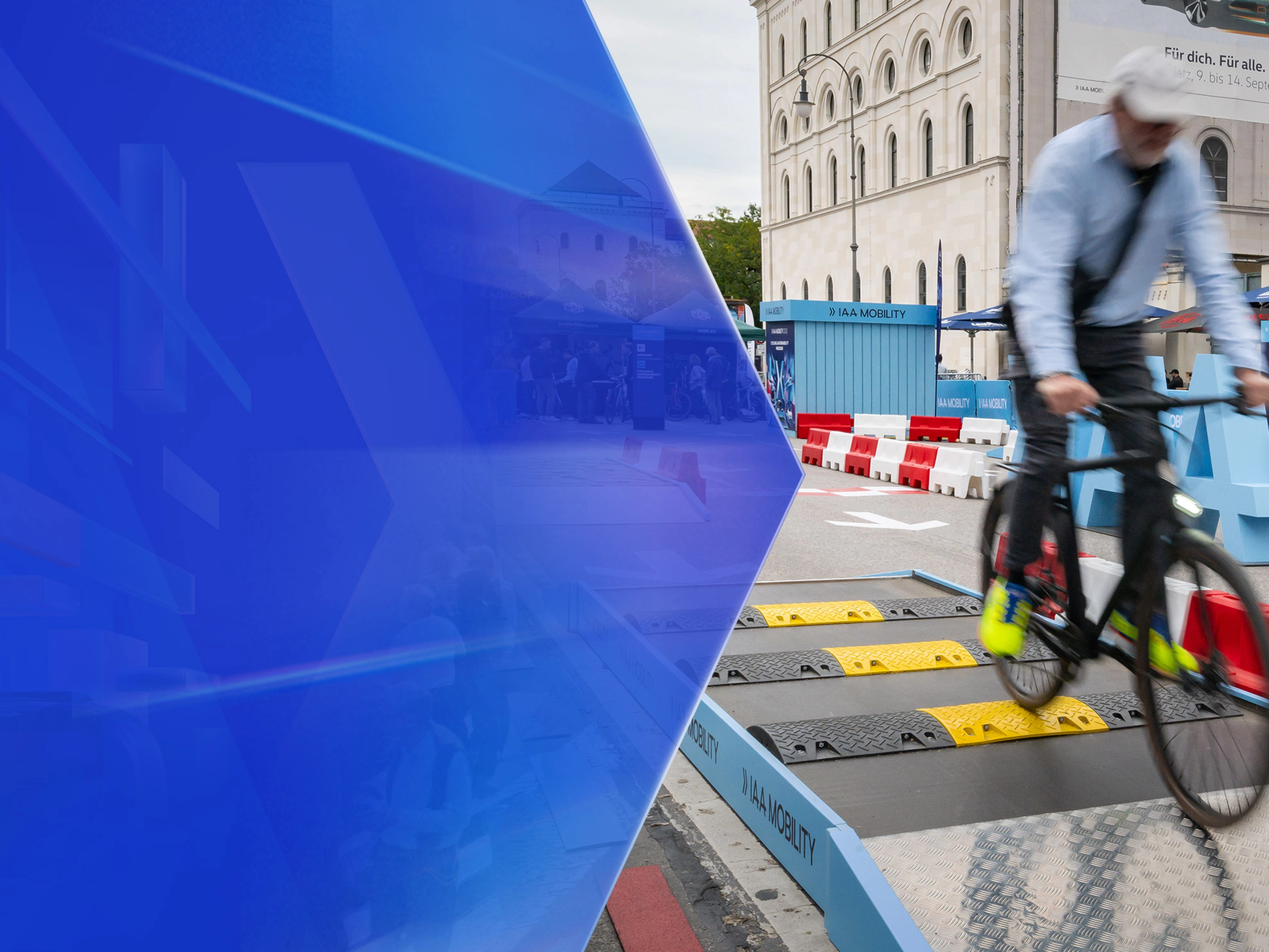 Man riding a bicycle over speed bumps on a test track at IAA Mobility.