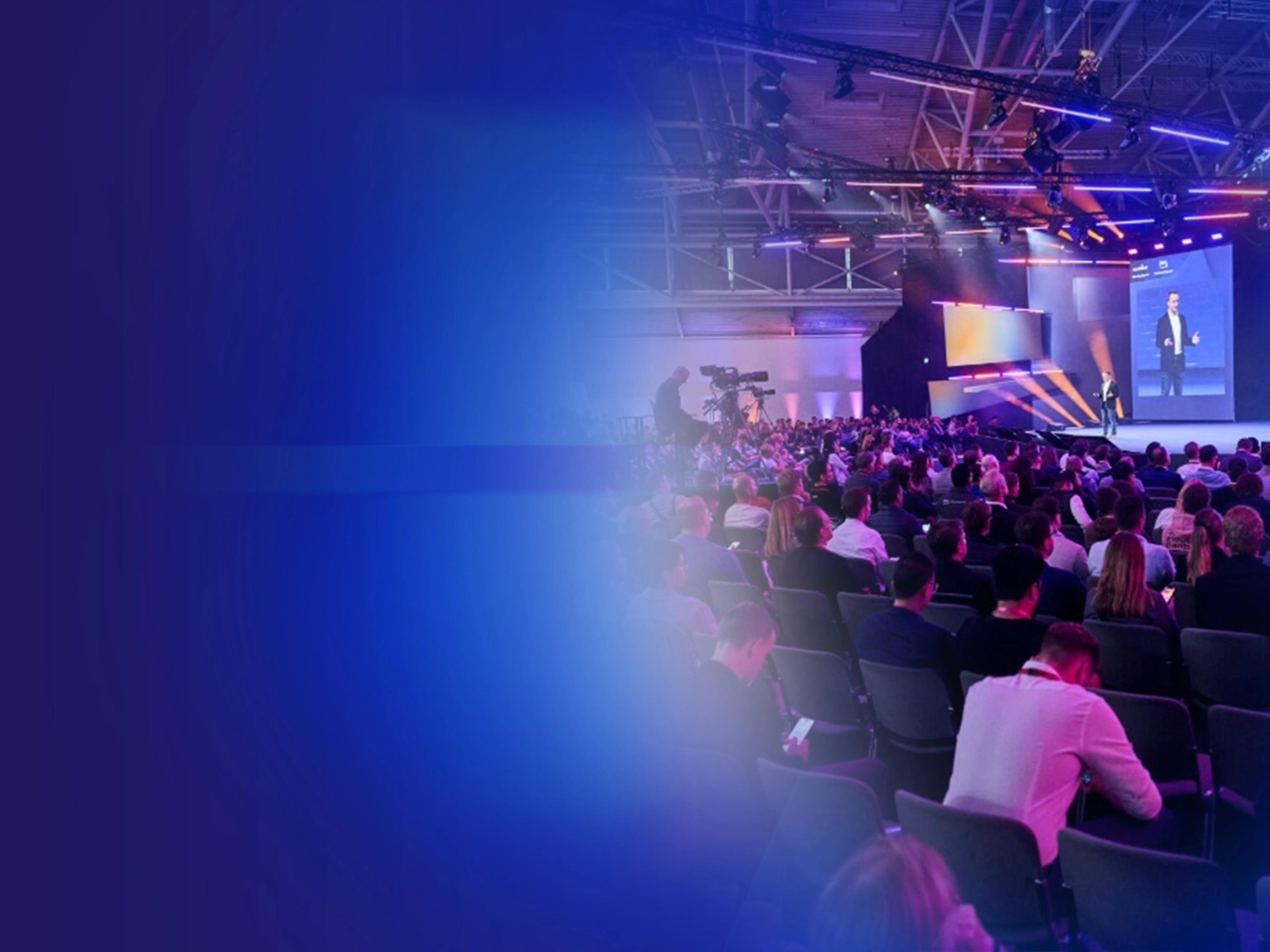 Promotional banner showing a conference audience and stage presentation.