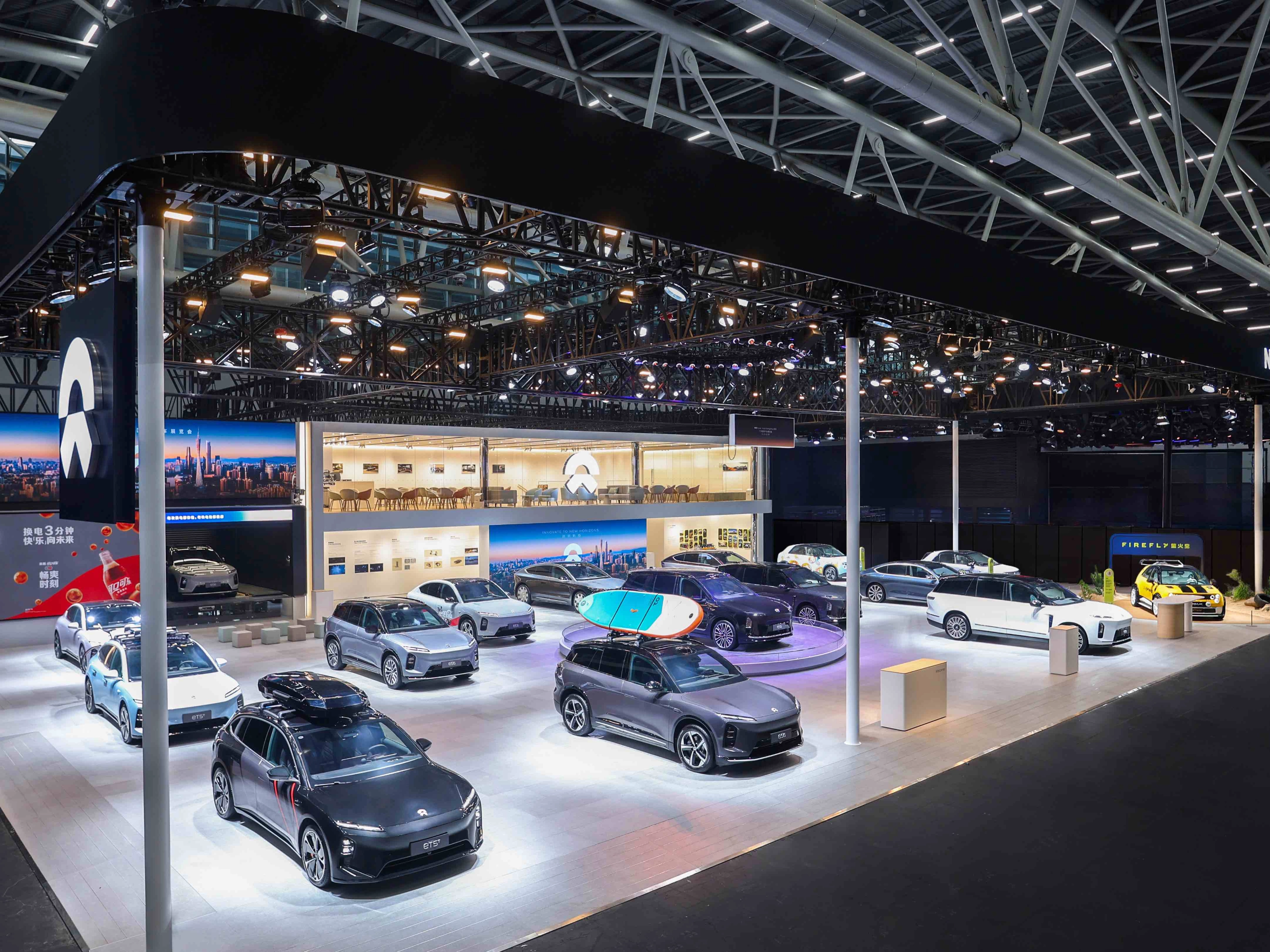 NIO exhibition booth displaying multiple electric cars at an auto show.