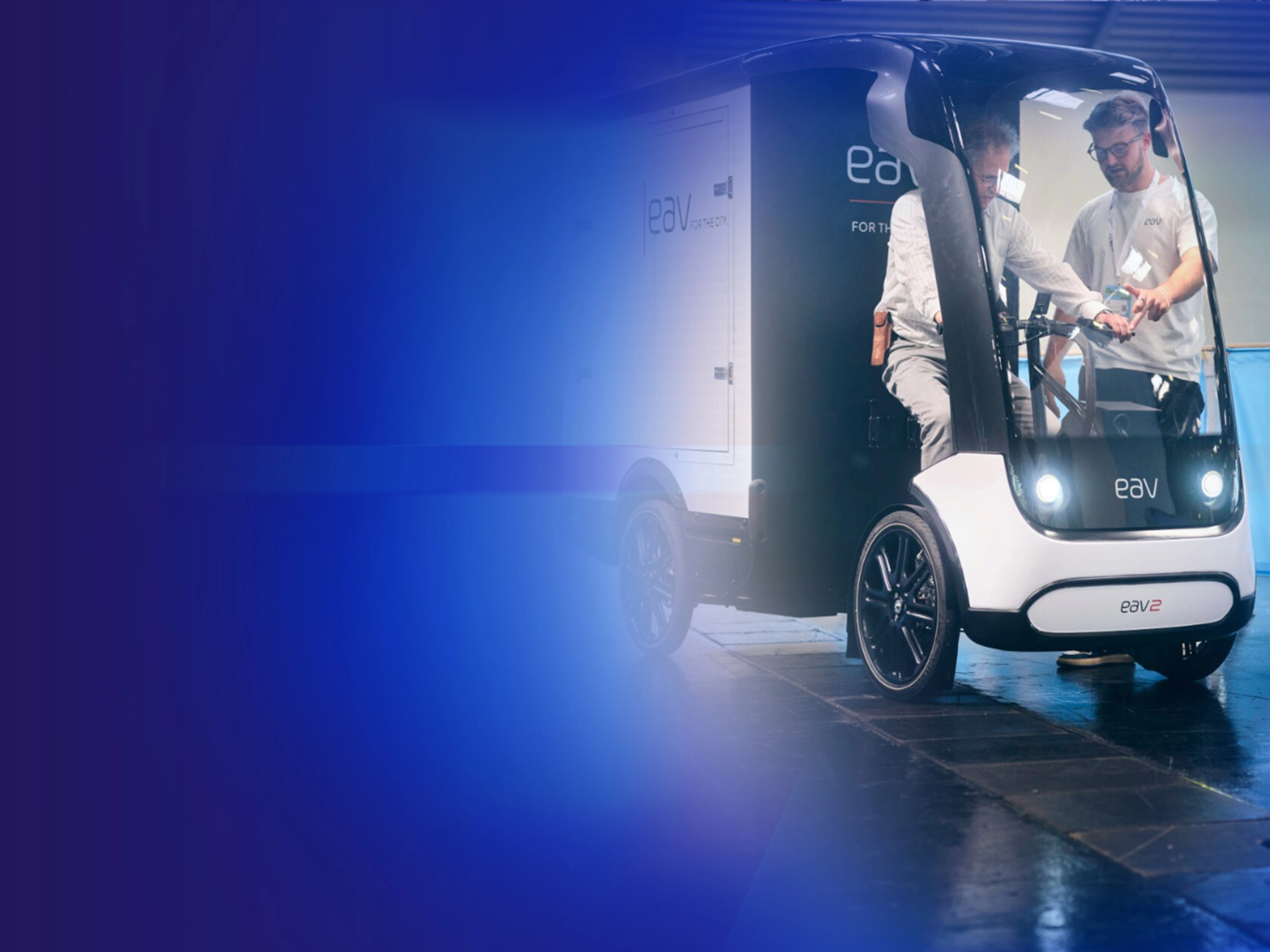 Promotional banner showing an autonomous delivery vehicle on a blue background.