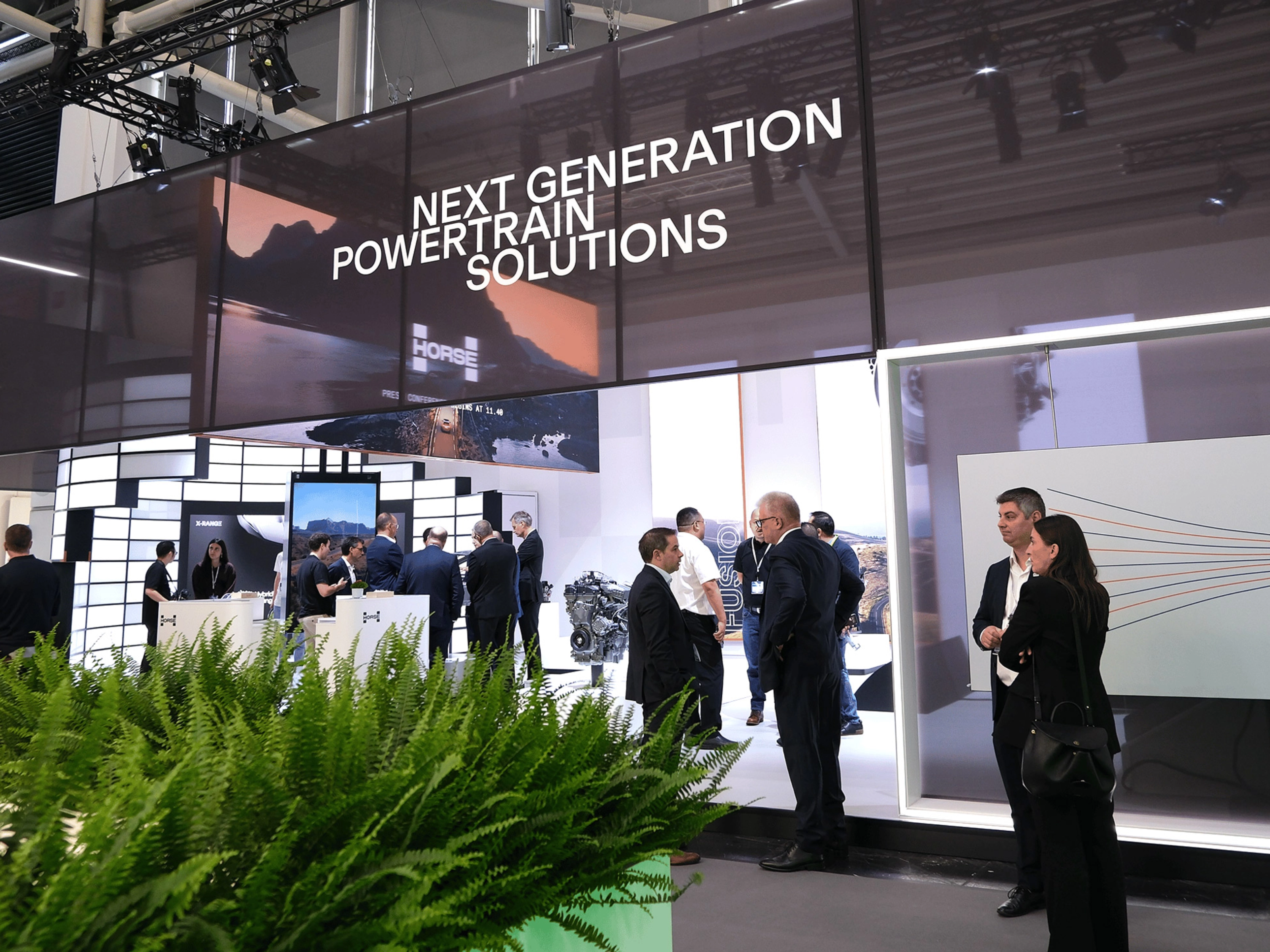 Horse Powertrain exhibition booth with visitors at an automotive trade show.