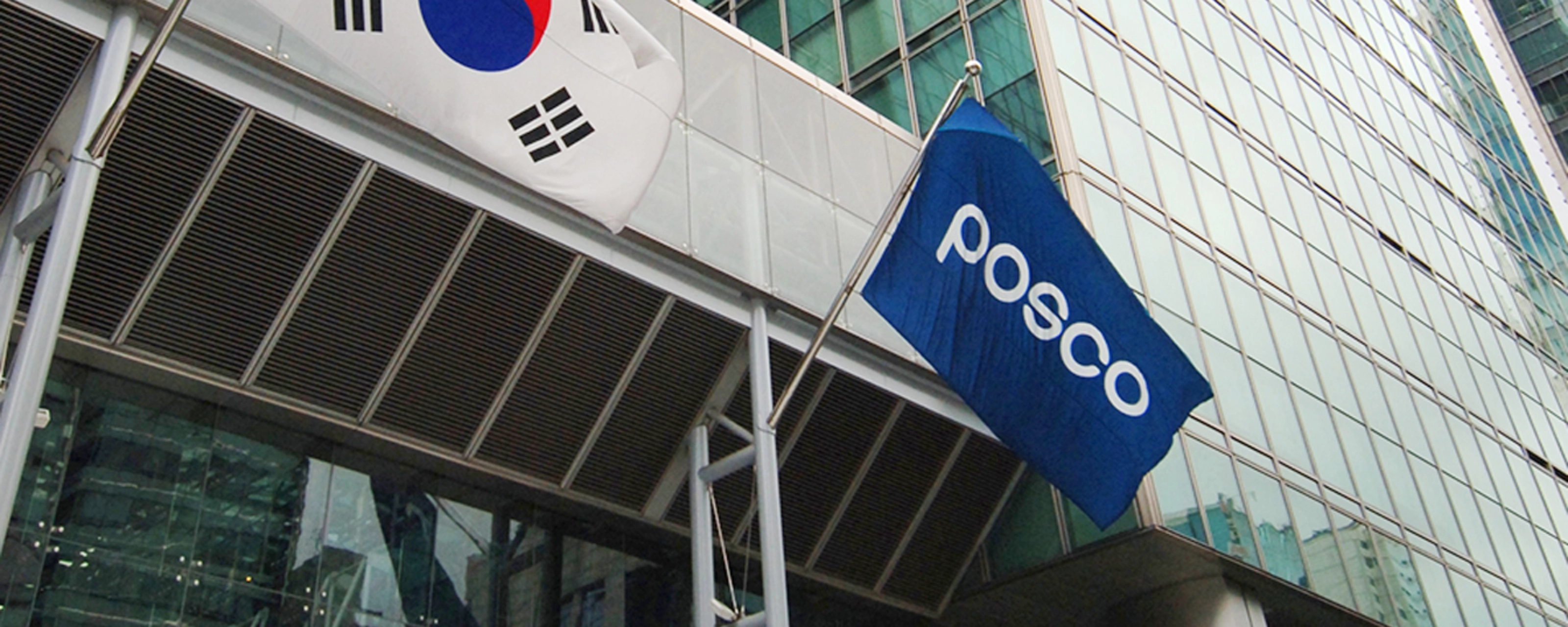 POSCO building entrance with company logo and South Korean flag.