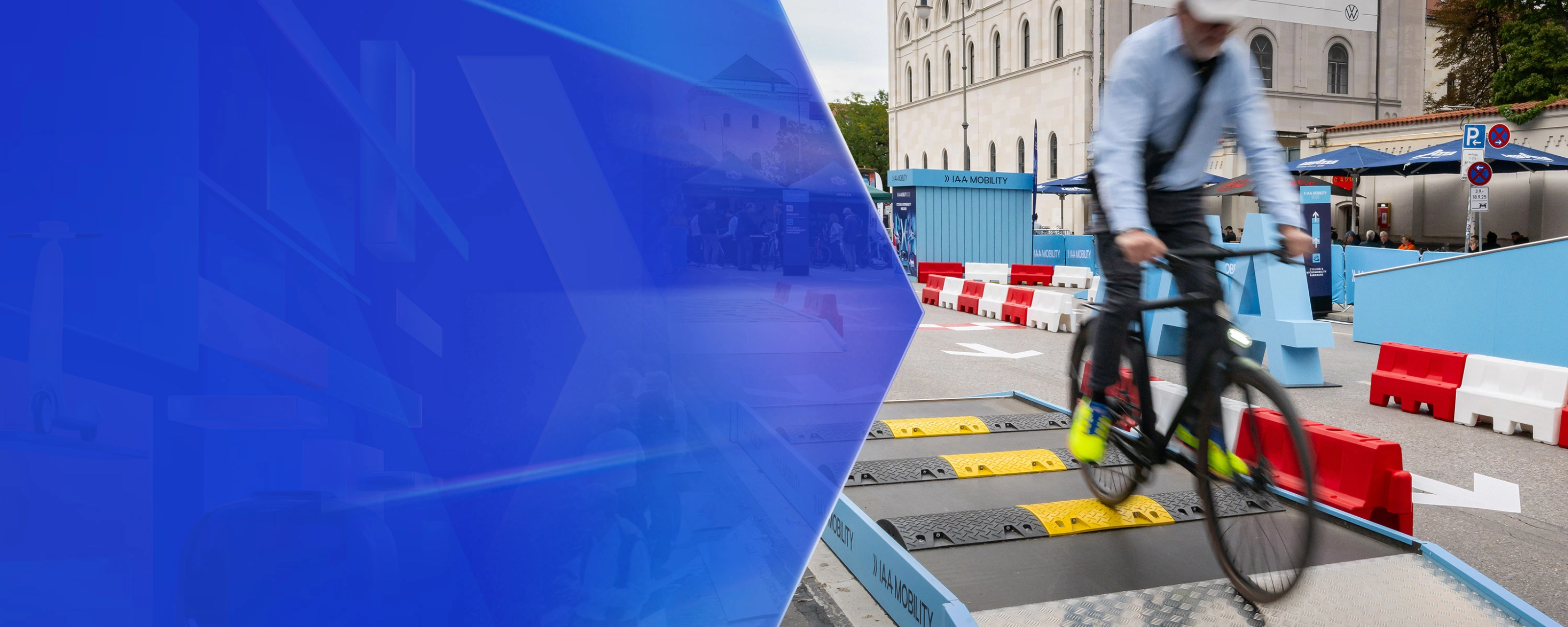 Man riding a bicycle over speed bumps on a test track at IAA Mobility.