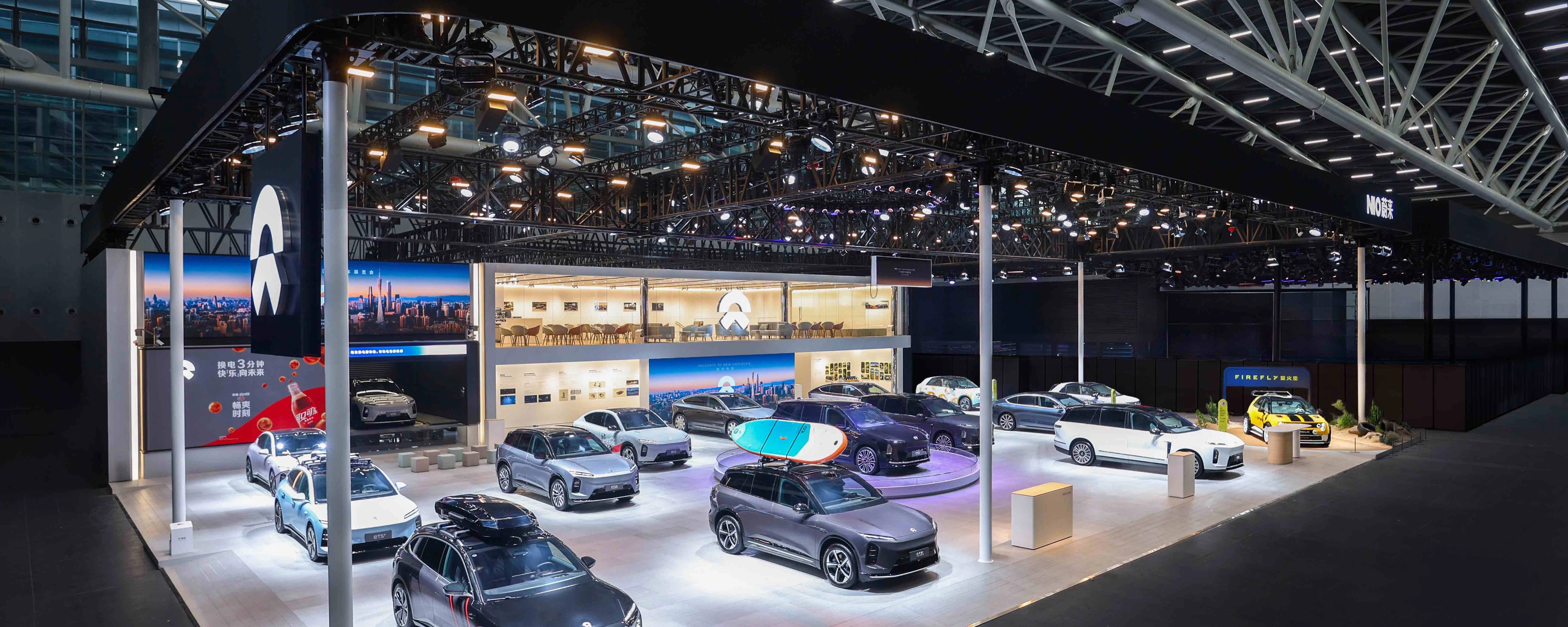 NIO exhibition booth displaying multiple electric cars at an auto show.
