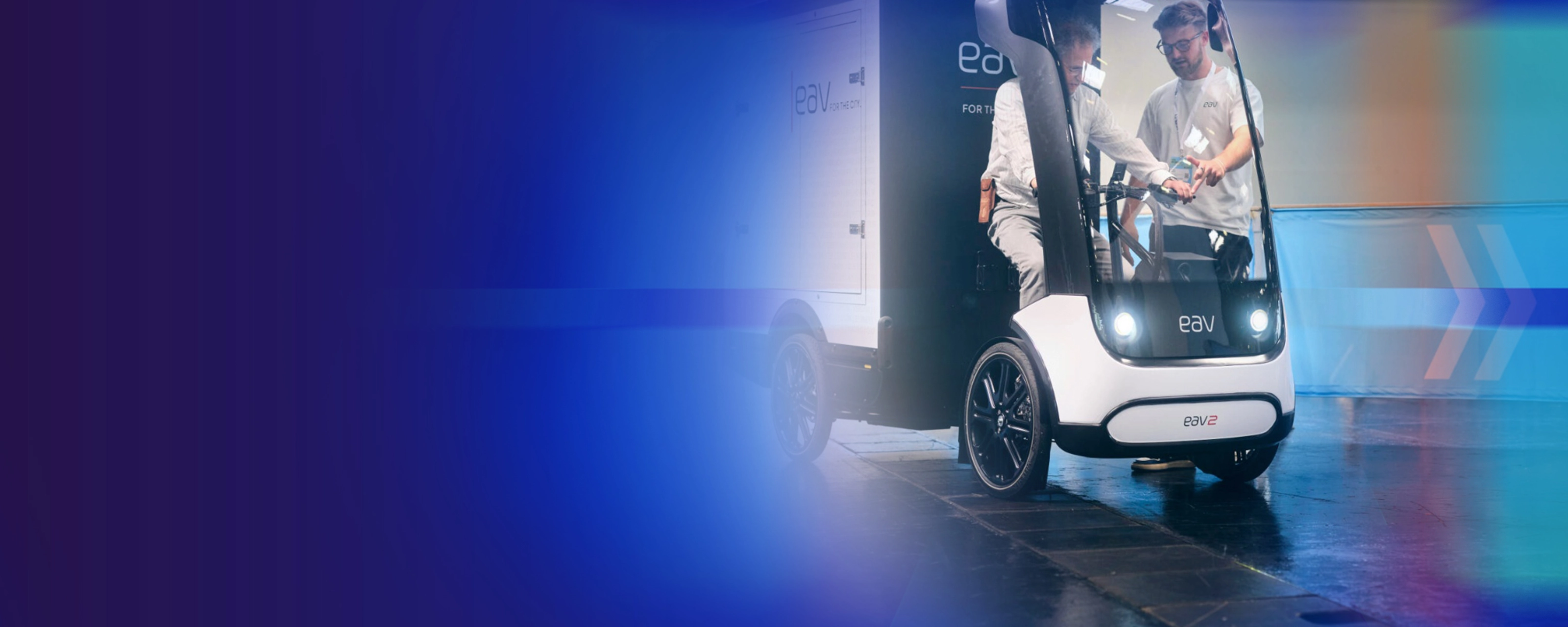Promotional banner showing an autonomous delivery vehicle on a blue background.