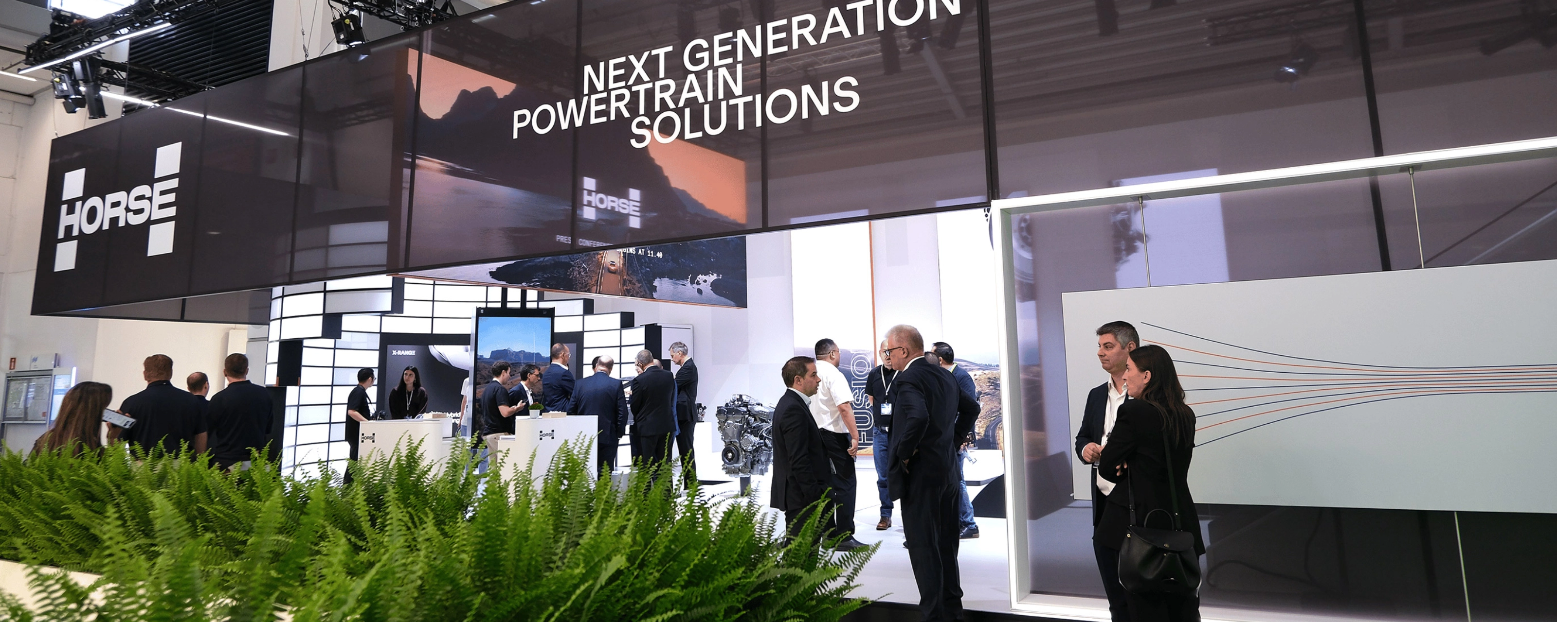 Horse Powertrain exhibition booth with visitors at an automotive trade show.