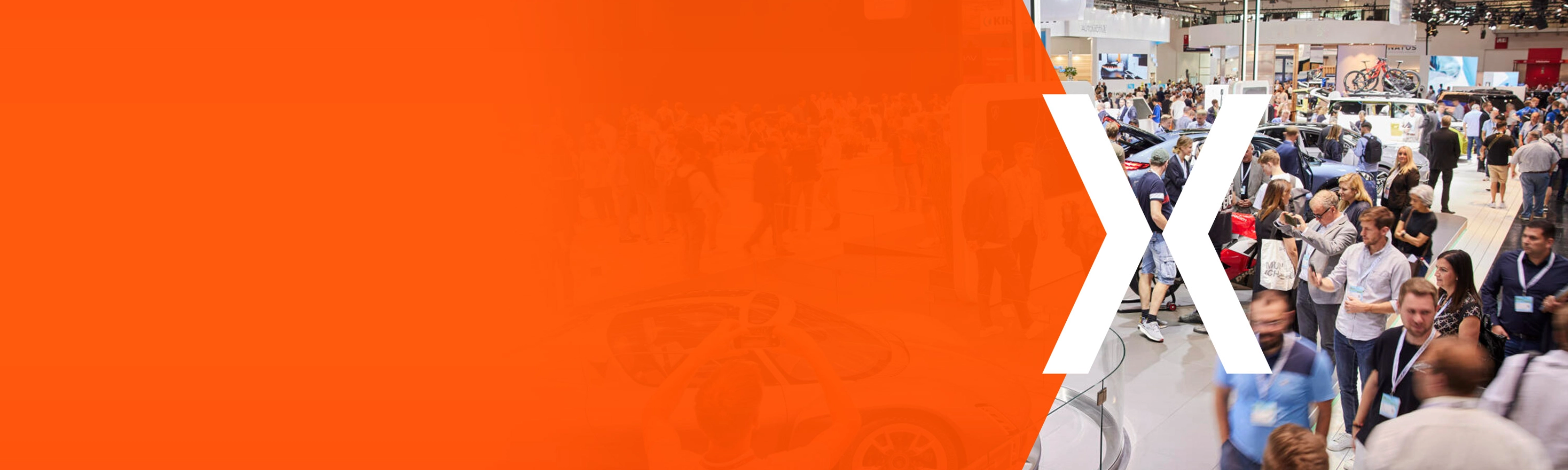 Trade fair hall with many visitors and an orange area featuring a large white X.