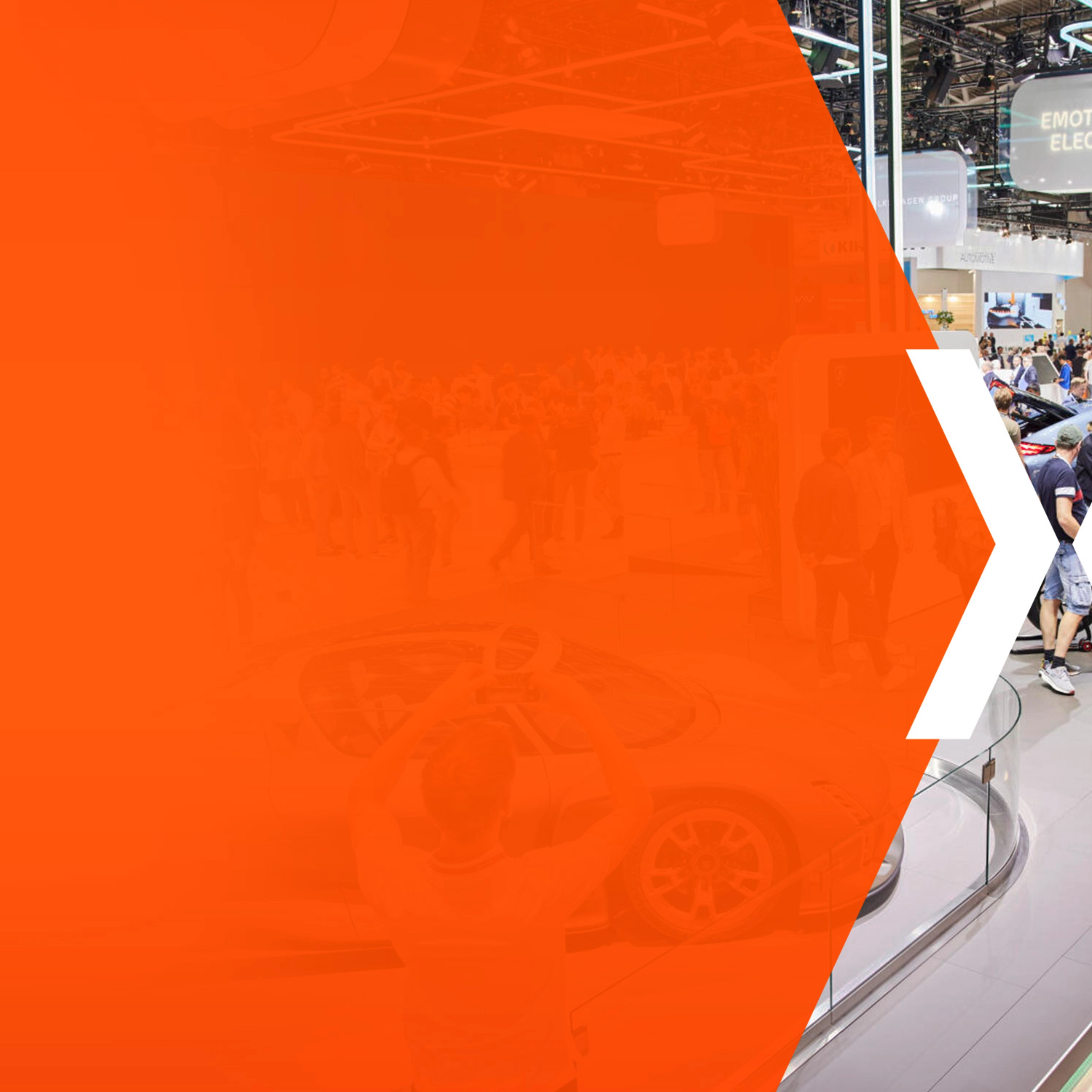 Trade fair hall with many visitors and an orange area featuring a large white X.