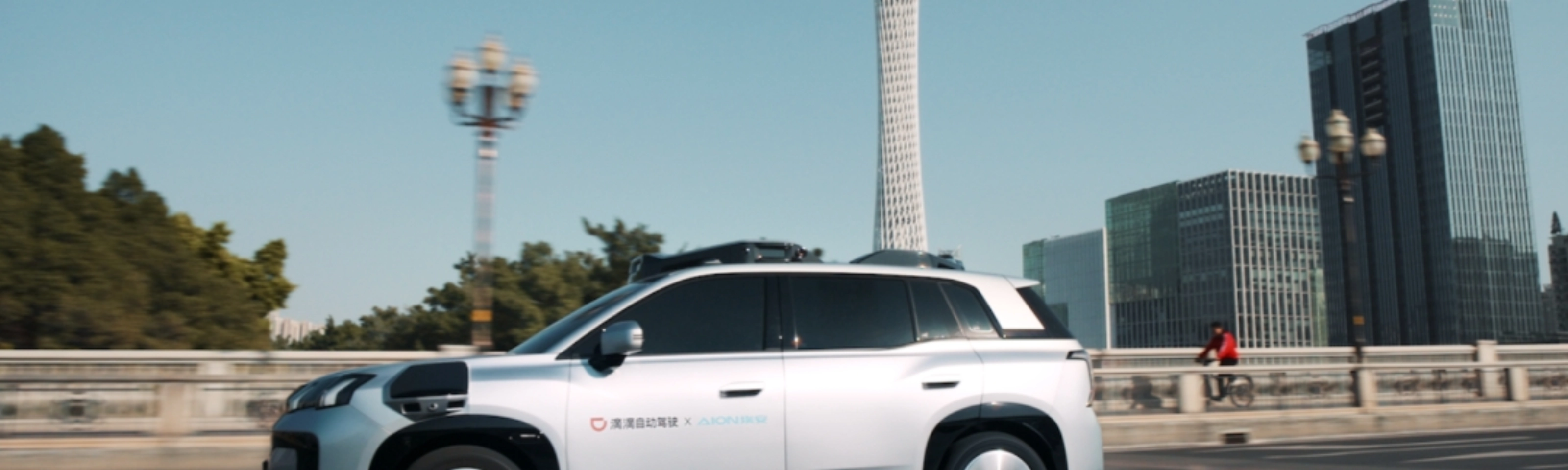 Ein autonomes SUV fährt durch eine Stadt mit modernen Gebäuden im Hintergrund.