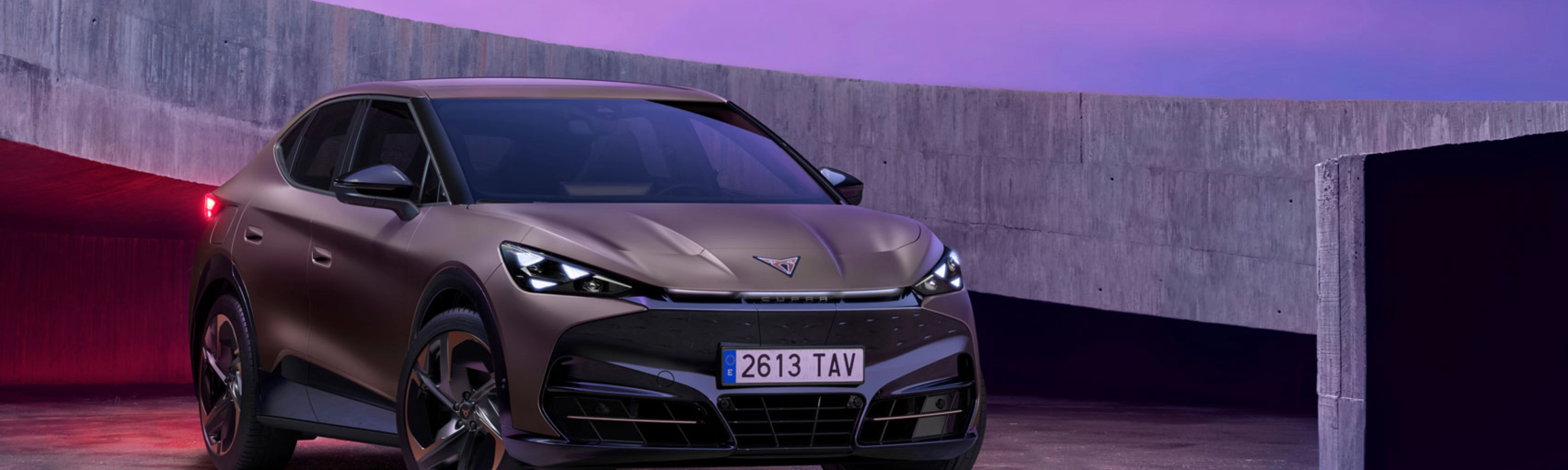 Cupra car parked in modern concrete setting with purple lighting.