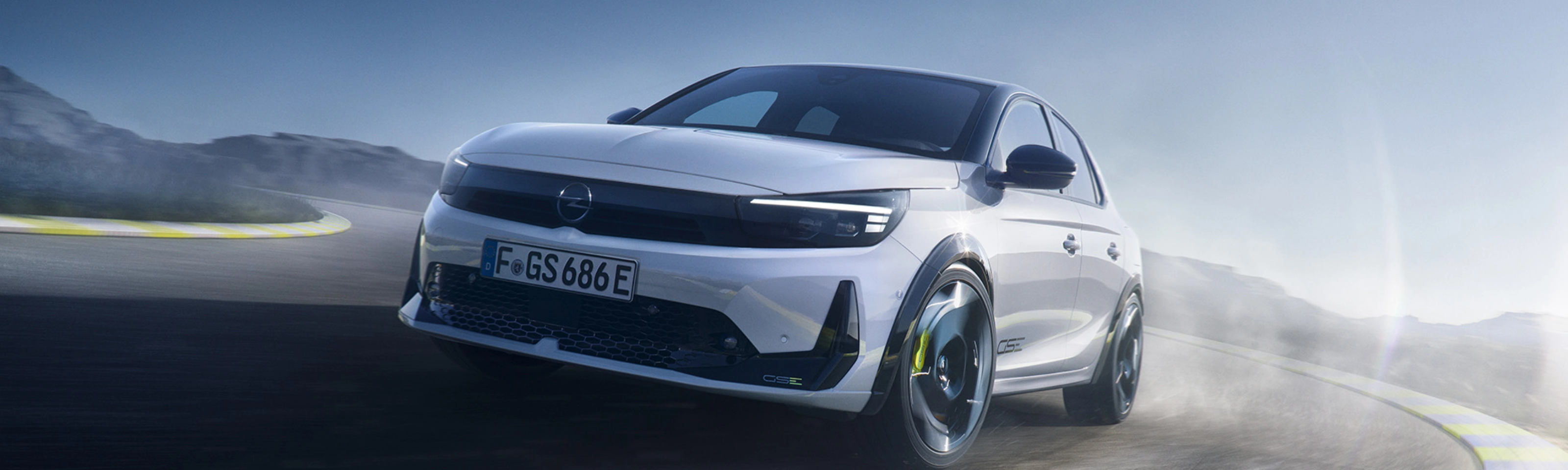 Opel GS Elektroauto fährt schnell in einer Kurve auf einer Rennstrecke.