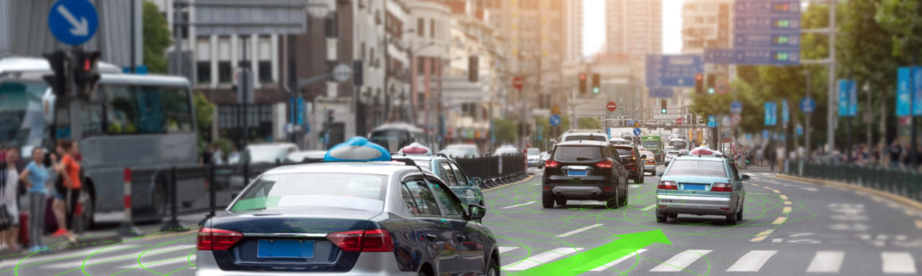 Car driving through a city street with lane guidance highlighted by driver assistance.