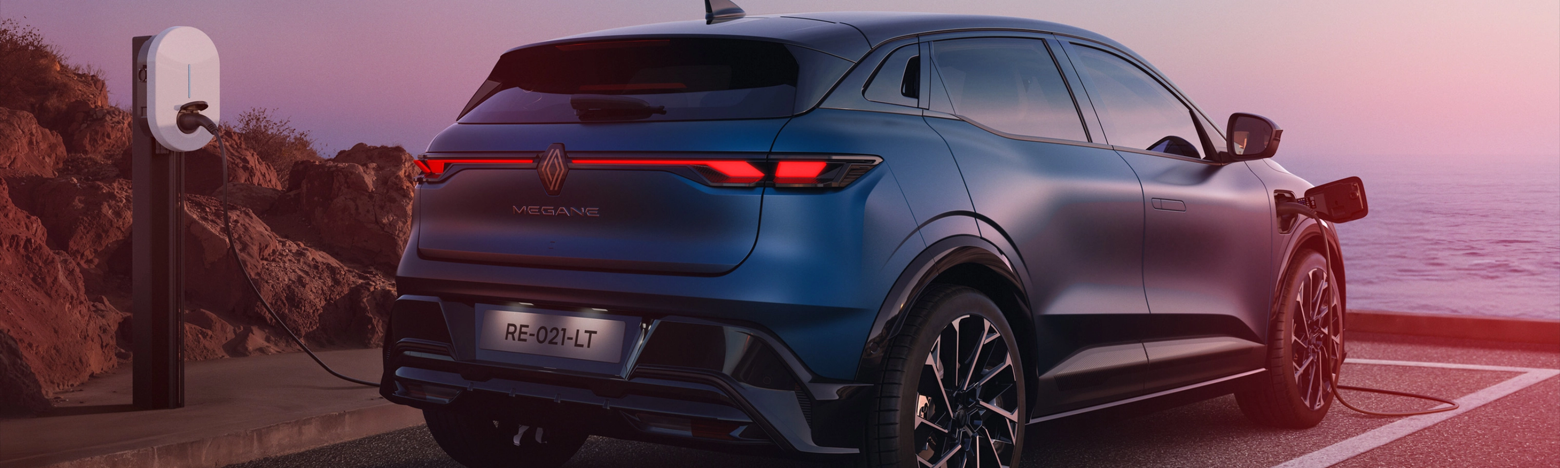Heckansicht eines Renault Megane E-Tech beim Laden an einer E-Ladestation.